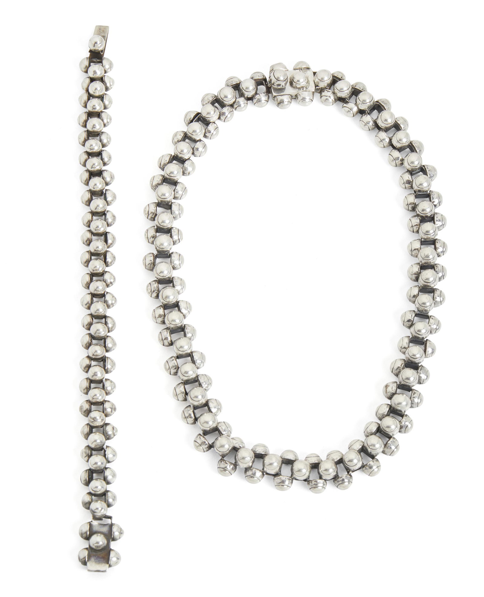 A set of William Spratling "Caviar" silver jewelry: 1940-1944; First Design Period; Taxco, Mexico Necklace stamped for William Spratling; Further stamped: Made in Mexico; Each stamped: Silver Each designed with caviar-shaped clusters, comprising a chok