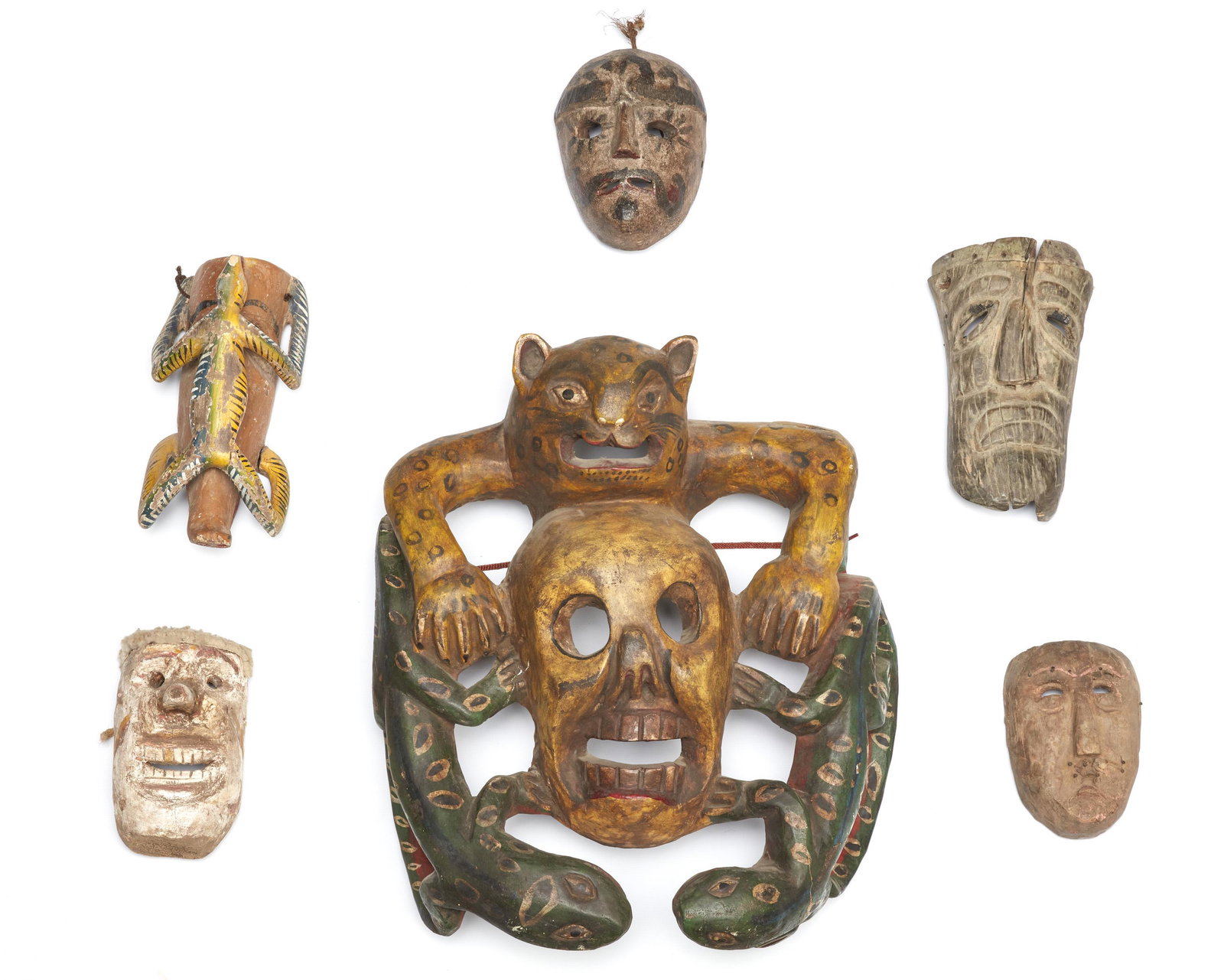 Six Mexican festival masks: 20th Century; Mexico Each polychromed carved wood, comprising five figural and zoomorphic masks and one large jaguar and serpent mask, 6 pieces Largest: 21.25" H x 19" W x 9" D; Smallest: 7.25" H x 5"