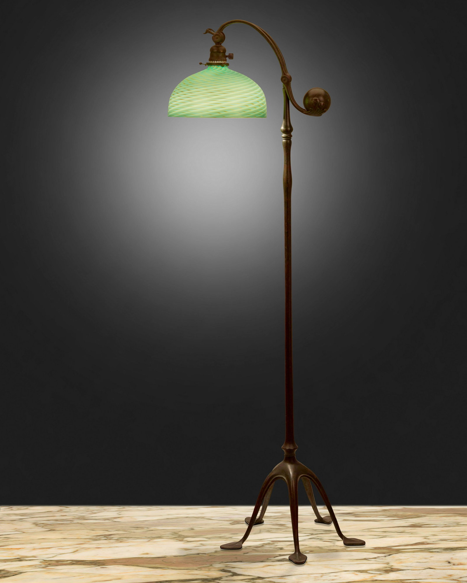 A Tiffany Studios counter-balance floor lamp: Circa 1902-1919; New York, NY Shade bears L.C.T. signature; Based signed: Tiffany Studios / New York / 468 The green iridescent Favrile-style art glass shade on a single-light patinated bronze Tiffany