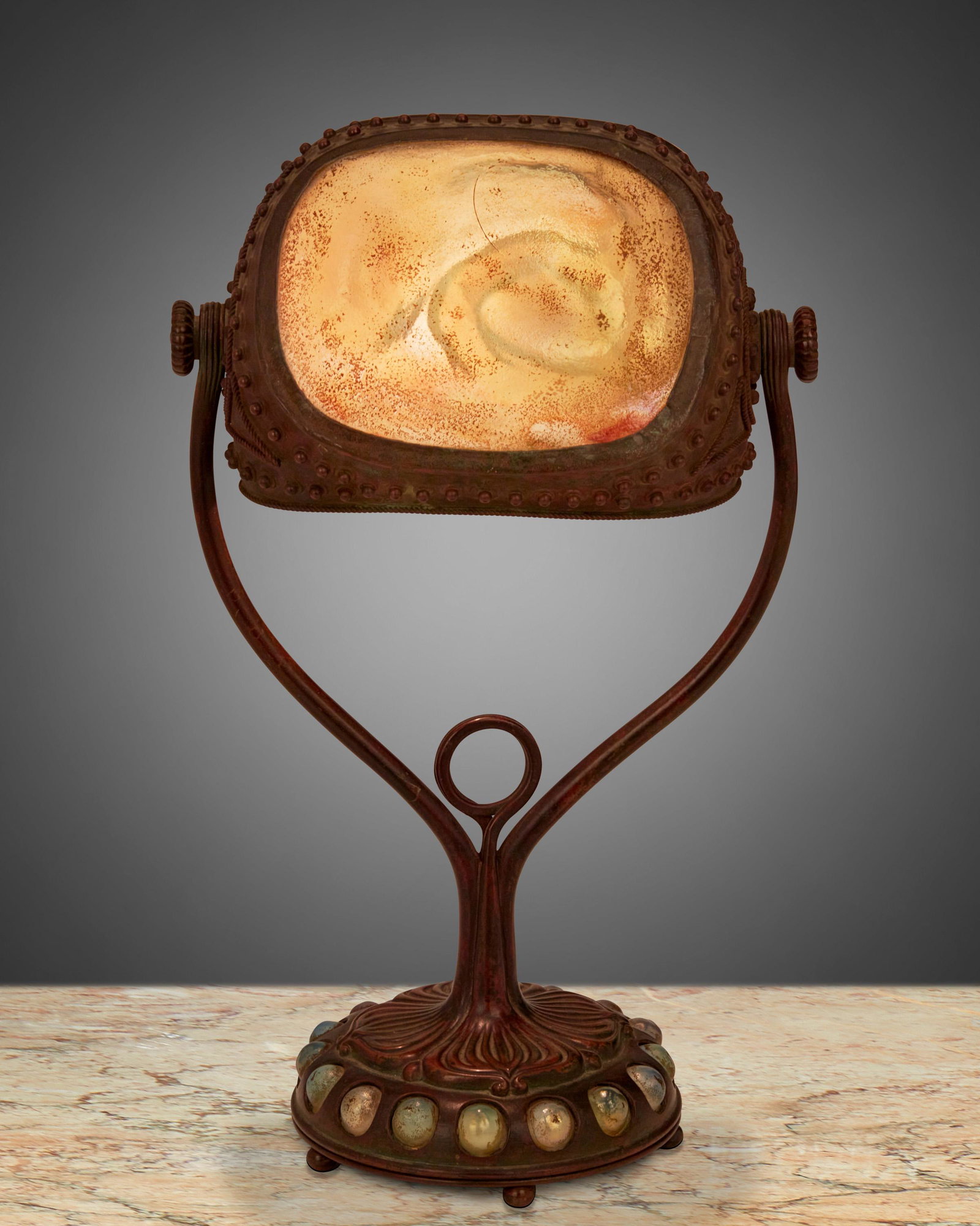 A Tiffany Studios "Turtle-Back" seal lamp: Circa 1902-1919; New York, NY Signed: Tiffany Studios / New York / 408 The "Turtle-Back" shade with gold iridescent glass and hobnail design on a patinated bronze base with iridescent cabochons and fl
