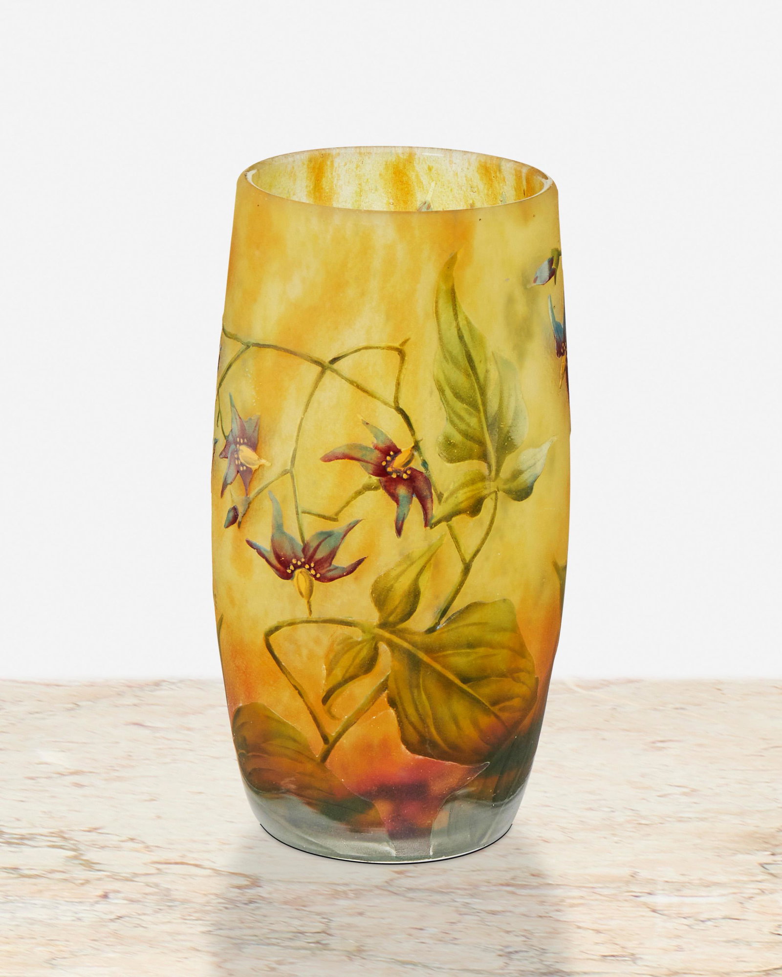 A Daum cameo glass "Orchid" vase: First-quarter 20th Century; Nancy, France Signed: Daum Nancy / France [Croix de Lorraine] The acid-etched cameo glass vase cut to mottled orange and yellow frost with enameled orchid motif 4.75" H x 2