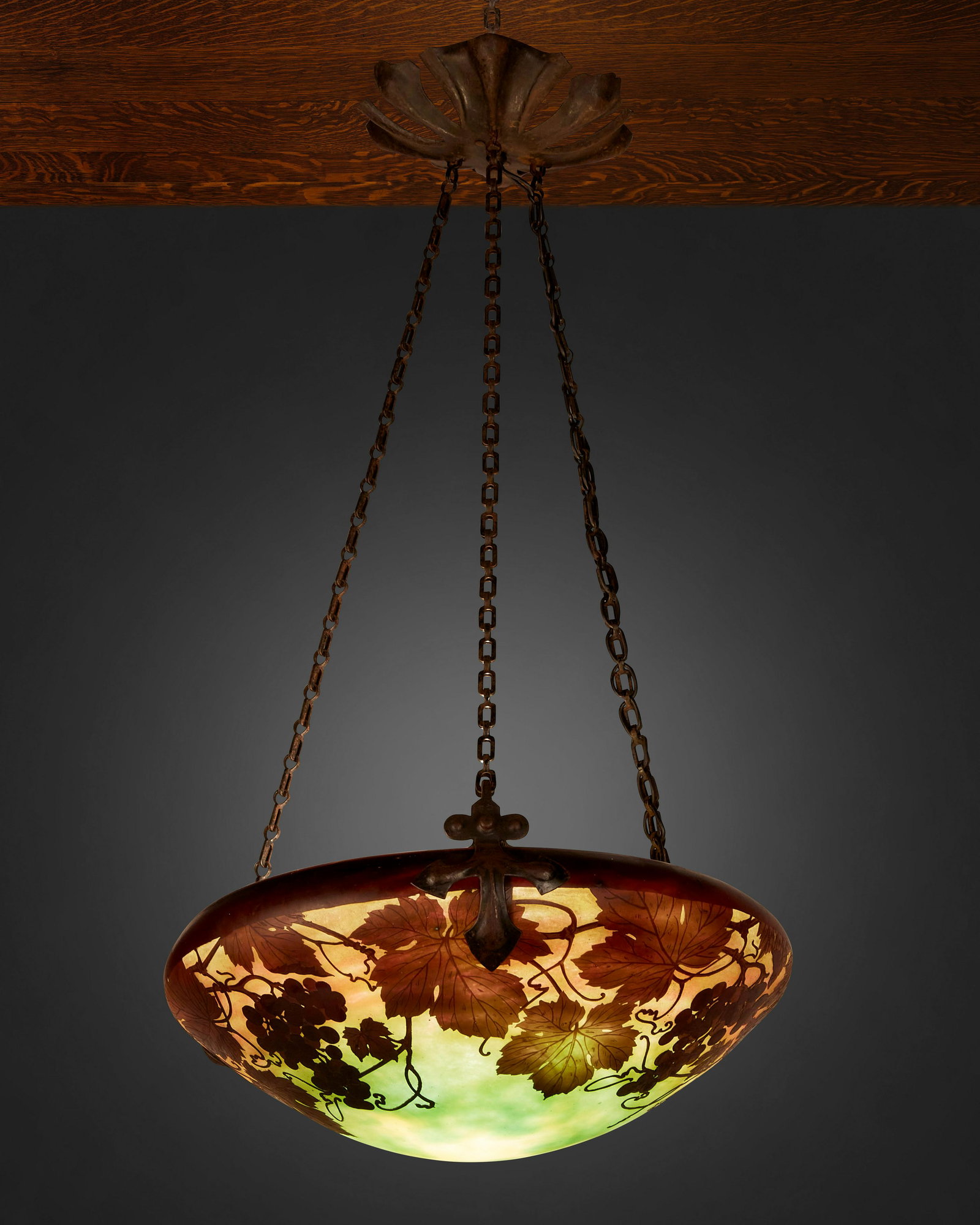 A Daum cameo glass "Grape and Vine" pendant chandelier: First-quarter 20th Century; Nancy, France Signed: Daum Nancy [Croix de Lorraine] The acid-etched cameo glass domical shade with grape and vine motifs cut from purple to light green and orange frost fi