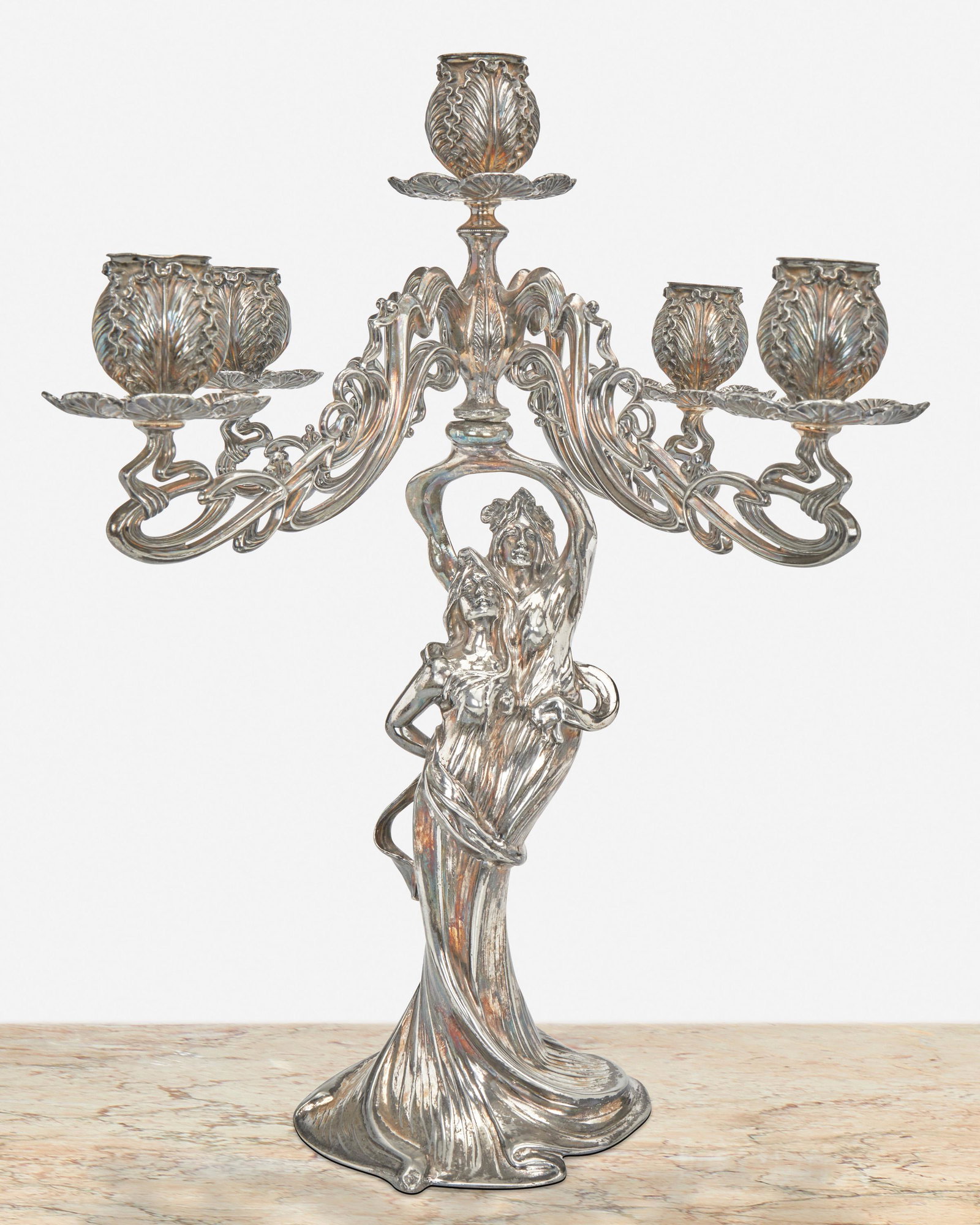 An American Art Nouveau silver plate candelabrum: Late 19th/early 20th Century Marked for E.G. Webster & Son; Further marked: 3305 The silver plate candelabrum with figural column issuing four swirling arms and one central arm, each terminating in ca