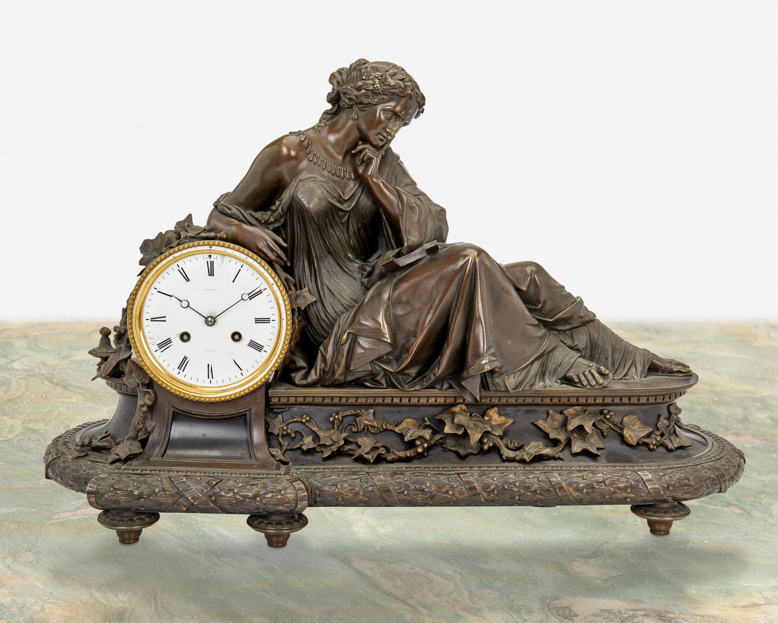 A Tiffany & Co. bronze mantel clock: Fourth-quarter 19th Century Dial signed: Tiffany & Co.; Movement marked: 252 20-5 The clock with white metal dial, black Roman numeral hour markers and minute track, Breguet hands, two train movemen