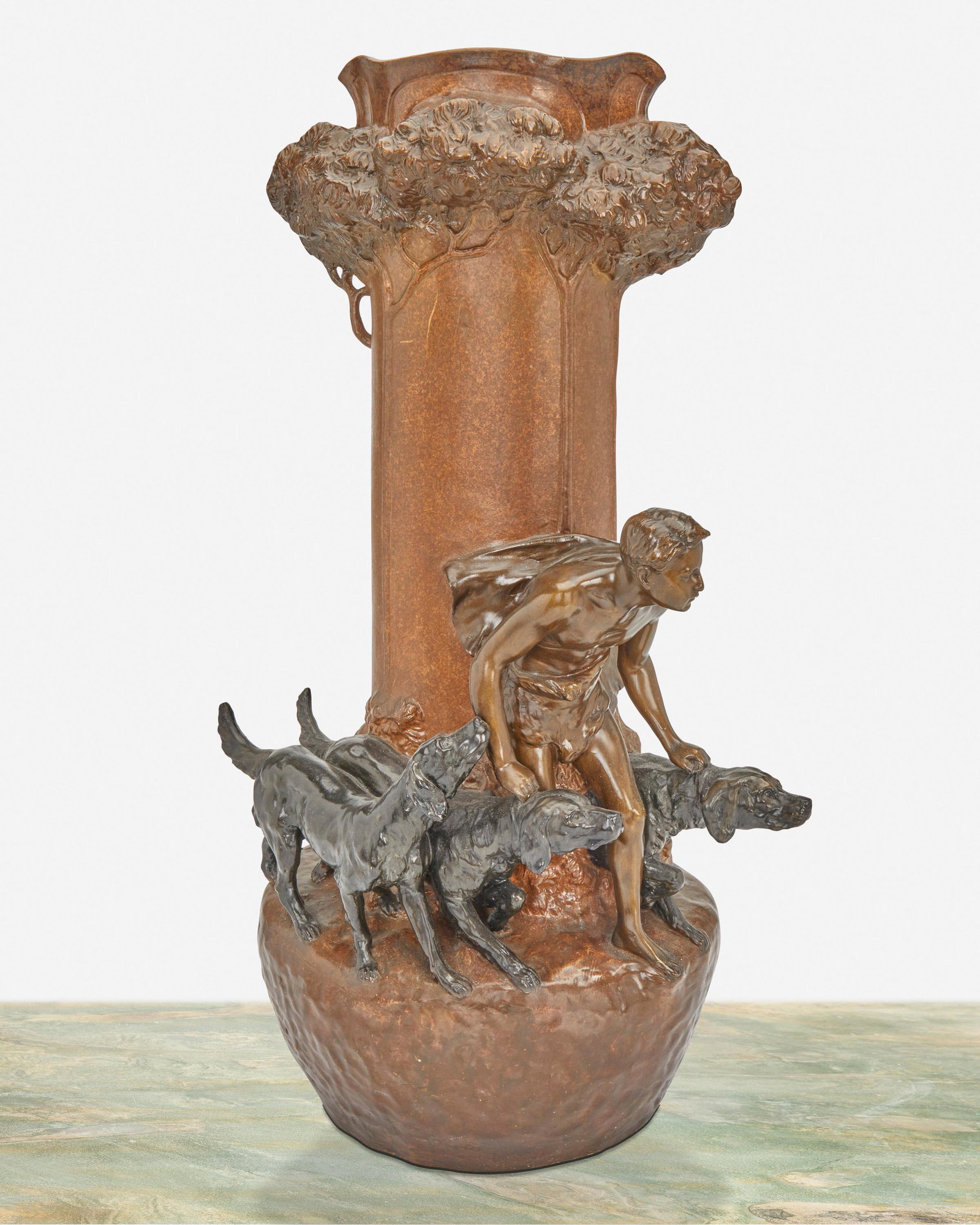 Friedrich Goldscheider (1845-1897, Austrian): Woodland vase with hunter and dogs Glazed terracotta Signed and numbered: Friedrich Goldscheider / Wien / Fabrique en Autriche / 01433 42 17 25" H x 15" W x 10" D Provenance: The Alan Schneider Collec