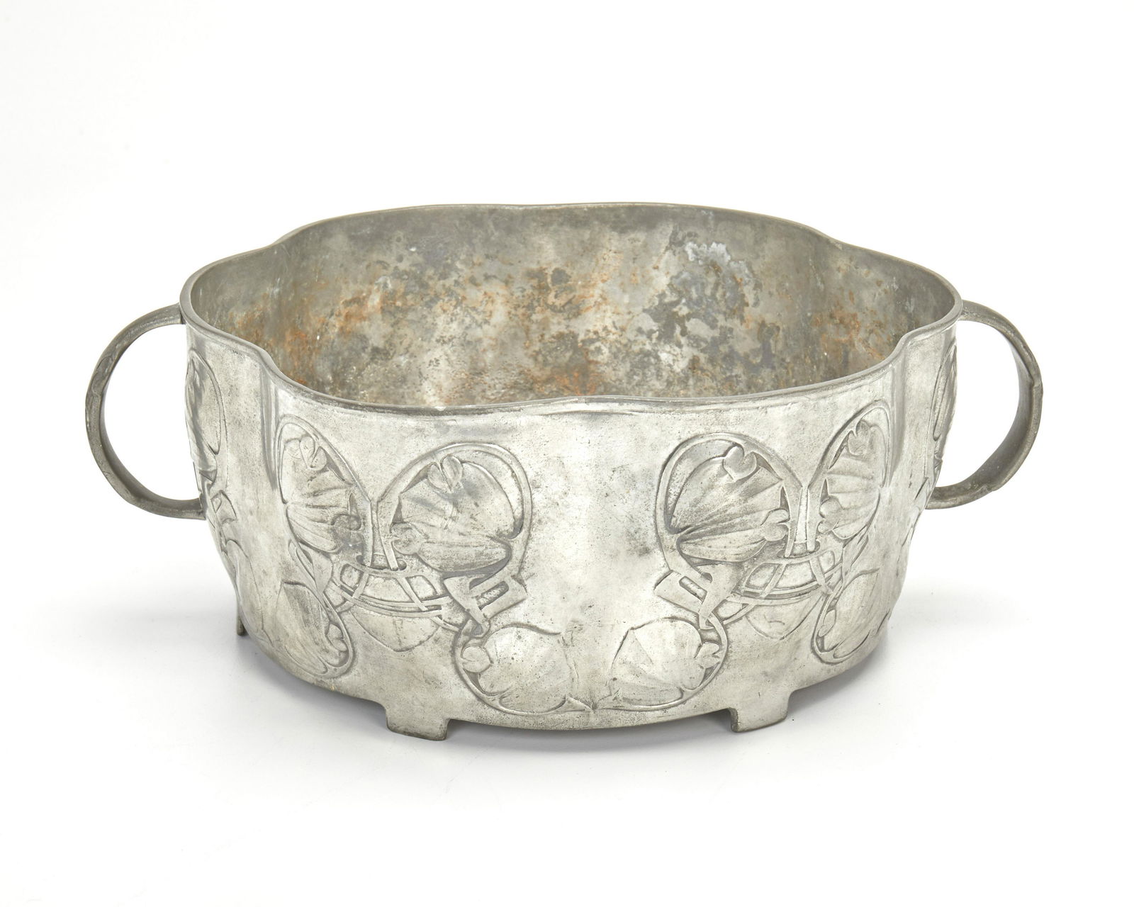 An Archibald Knox for Liberty & Co. Tudric pewter bowl: First-quarter 20th Century; England Marked: Tudric / 0755 / 7 / Made in England Designed by Archibald Knox for Liberty & Co. of London, the scallop-form footed pewter bowl with opposed handles and l