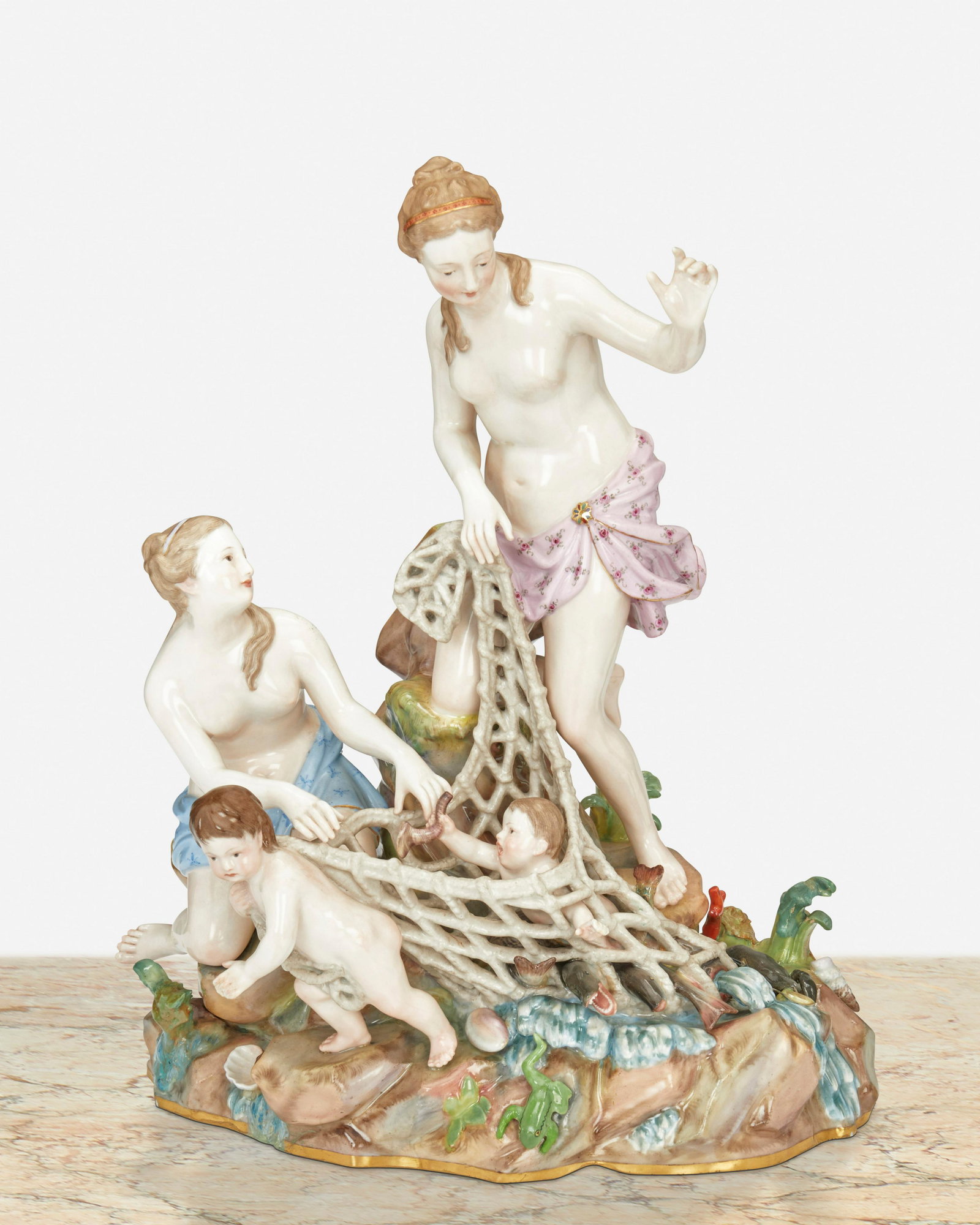 A Meissen "Capturing the Tritons" figural group: Late 19th/early 20th Century; Germany Marked for Meissen [Blue Crossed Swords underglaze]; Further marked: C 35 / 57 Originally designed by Kandler, Punct, and Schonheit, the porcelain mythological fi