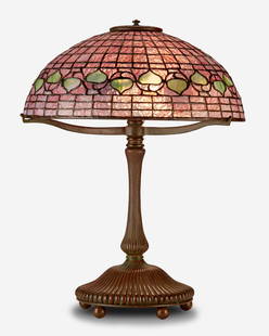 A Tiffany Studios "Acorn" table lamp: Circa 1902-1919; New York, NY Base spuriously signed: Tiffany Studios / New York / 28622 The pink and green leaded glass "Acorn" shade on a three-light patinated bronze Tiffany-style