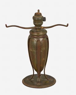 A Tiffany Studios "Greek" table lamp base: Circa 1902-1919; New York, NY Signed: Tiffany Studios / New York / 441 The single-light patinated bronze narrow urn-form "Greek" table lamp base with three arms and four flared feet raised overall o