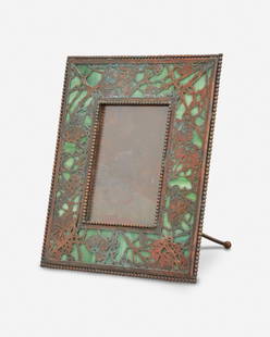 A Tiffany Studios "Grape Vine" bronze picture frame: Circa 1902-1919; New York, NY Signed: Tiffany Studios / New York The rectangular verdigris patinated bronze "Grape Vine" frame with green mottled glass and bronze overlay enclosing a