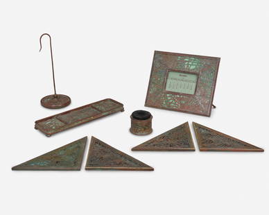 A group of Tiffany Studios "Pine Needle" desk set items: Circa 1902-1919; New York, NY Each signed: Tiffany Studios / New York; Further marked: 940 / 961 / 981 / 997 / 1004 Each mottled green glass with patinated bronze pine needle motif overlay, comprisi