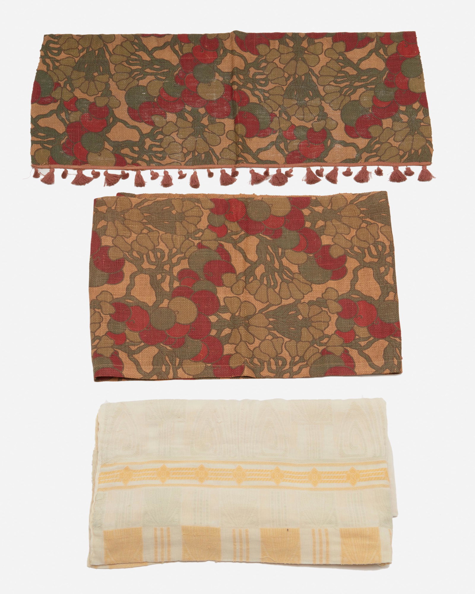 A collection of Arts and Crafts drapery panels: First-quarter 20th Century Appear unmarked Comprising one cream-colored panel with a pale green and yellow stylized geometric pattern, eight painted burlap drapery panels with stenciled red and green 