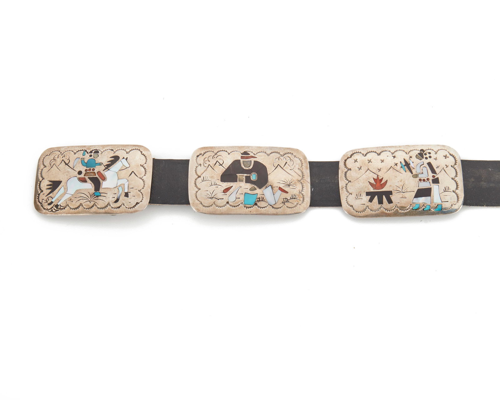 A Navajo Benjamin Becenti concho belt: Fourth-quarter 20th Century; Stamped: BB Designed with eight rectangular conchos and a buckle depicting scenes of everyday life inlaid with mother-of-pearl, coral, onyx, and turquoise 42.25" L x 1.825