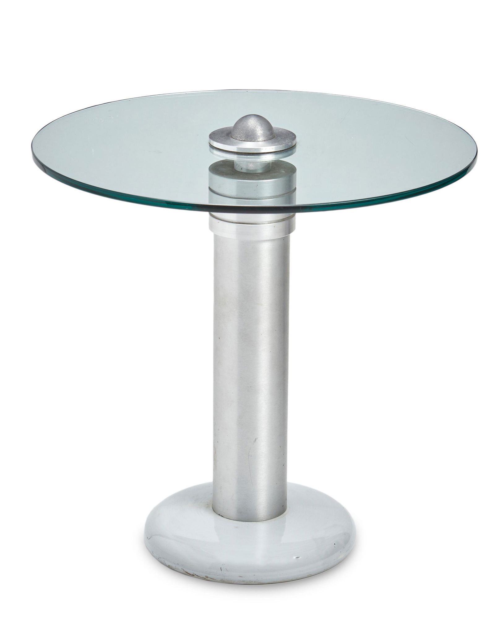 A Russel Wright-style Jet Age side table: Mid-20th Century The modern side table with a circular glass top over a brushed metal columnar base on a circular white glazed ceramic foot 20.75" H x 20" Dia. Provenance: From the Collection of t