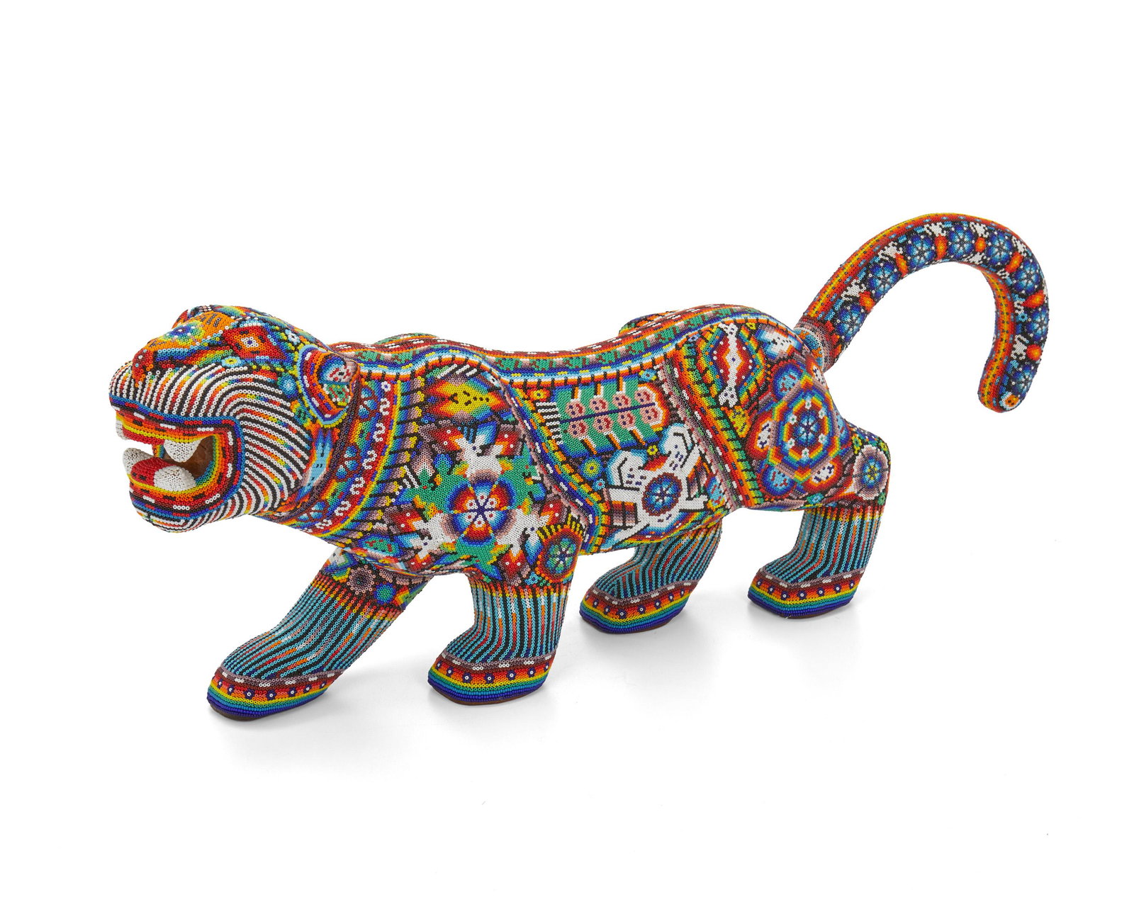 Victor Cueva (20th/21st Century, Mexican): Huichol beaded jaguar Beads on wood in acrylic case 9" H x 4.5" W x 26" D Provenance: The Collection of Dr. Denis Bettencourt