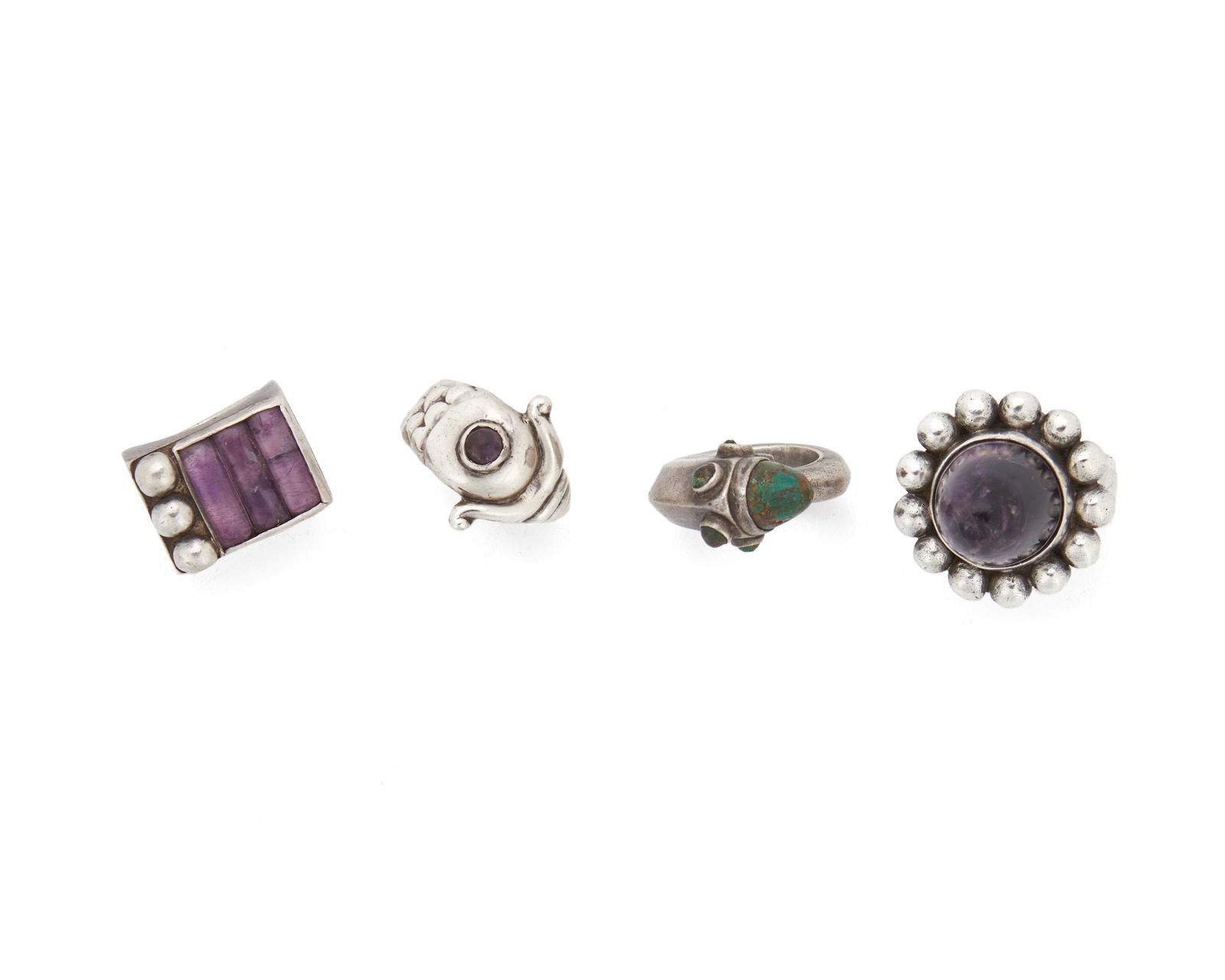Four Hubert Harmon stone-set rings: Circa 1942-1948; Taxco, Mexico Stamped with winged feet for Hubert Harman; Further stamped: Made in Mexico Comprising a ring set with a high domed amethyst (ring size: 8 with adjustable back), a rin