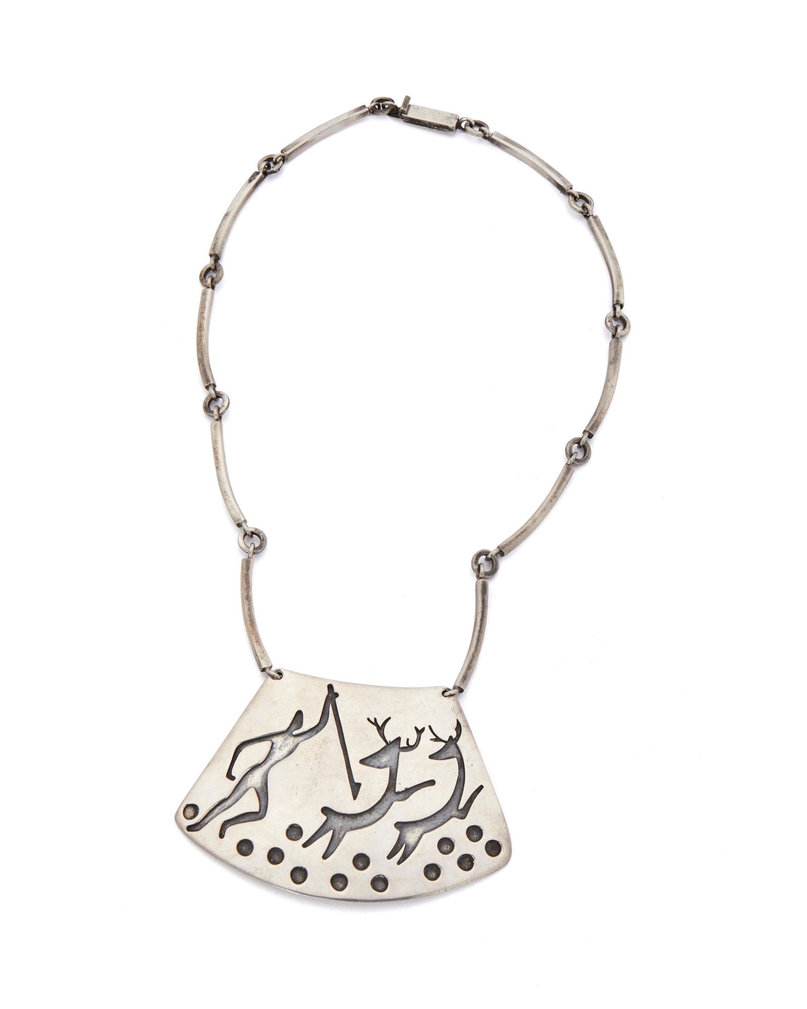 An Antonio Pineda Lascaux-motif sterling silver: Circa 1953-1979; Taxco, Mexico Crown mark for Antonio Pineda; Further stamped: Eagle 17 / Hecho en Mexico / 970 The trapezoid pendant designed with a Lascaux-inspired hunting scene suspended from an