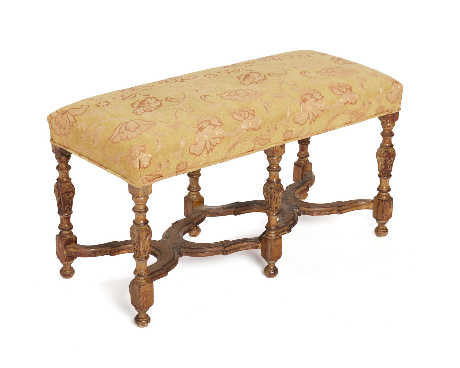 A carved wood bench: 19th Century With gold floral upholstery atop six carved and turned legs 20" H x 35.5" W x 15.5" D