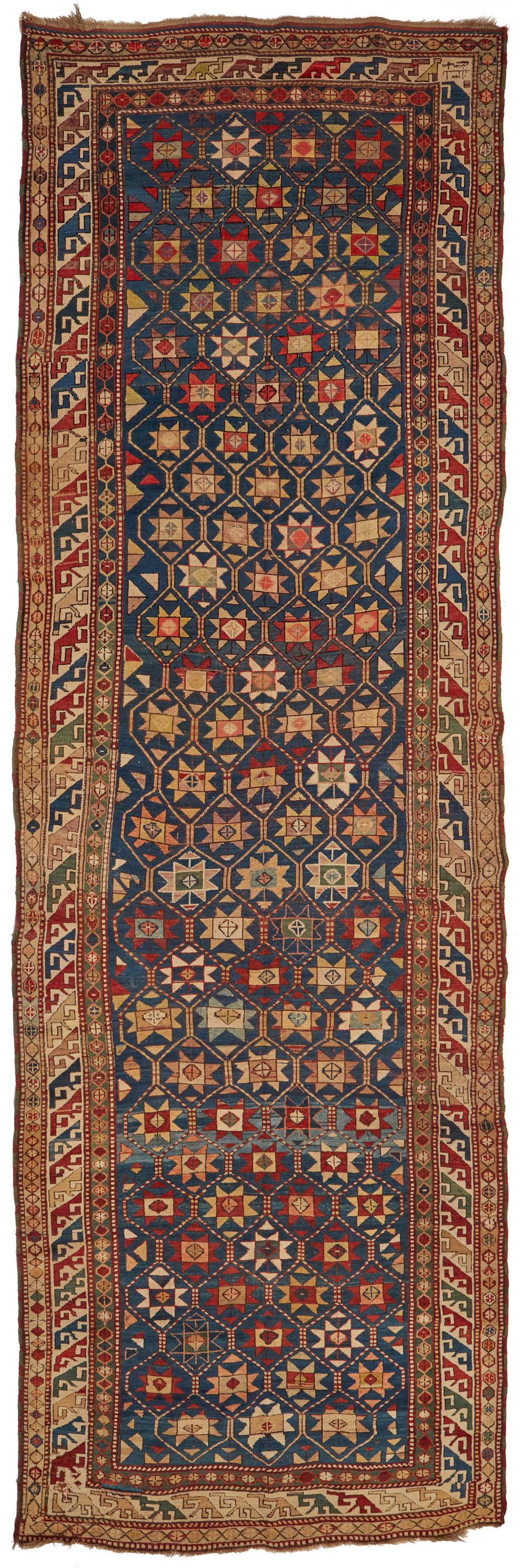 A large Karabakh area rug: First-quarter 20th Century Signed Wool on wool foundation, with polychrome geometric motifs throughout 191" L x 66" W