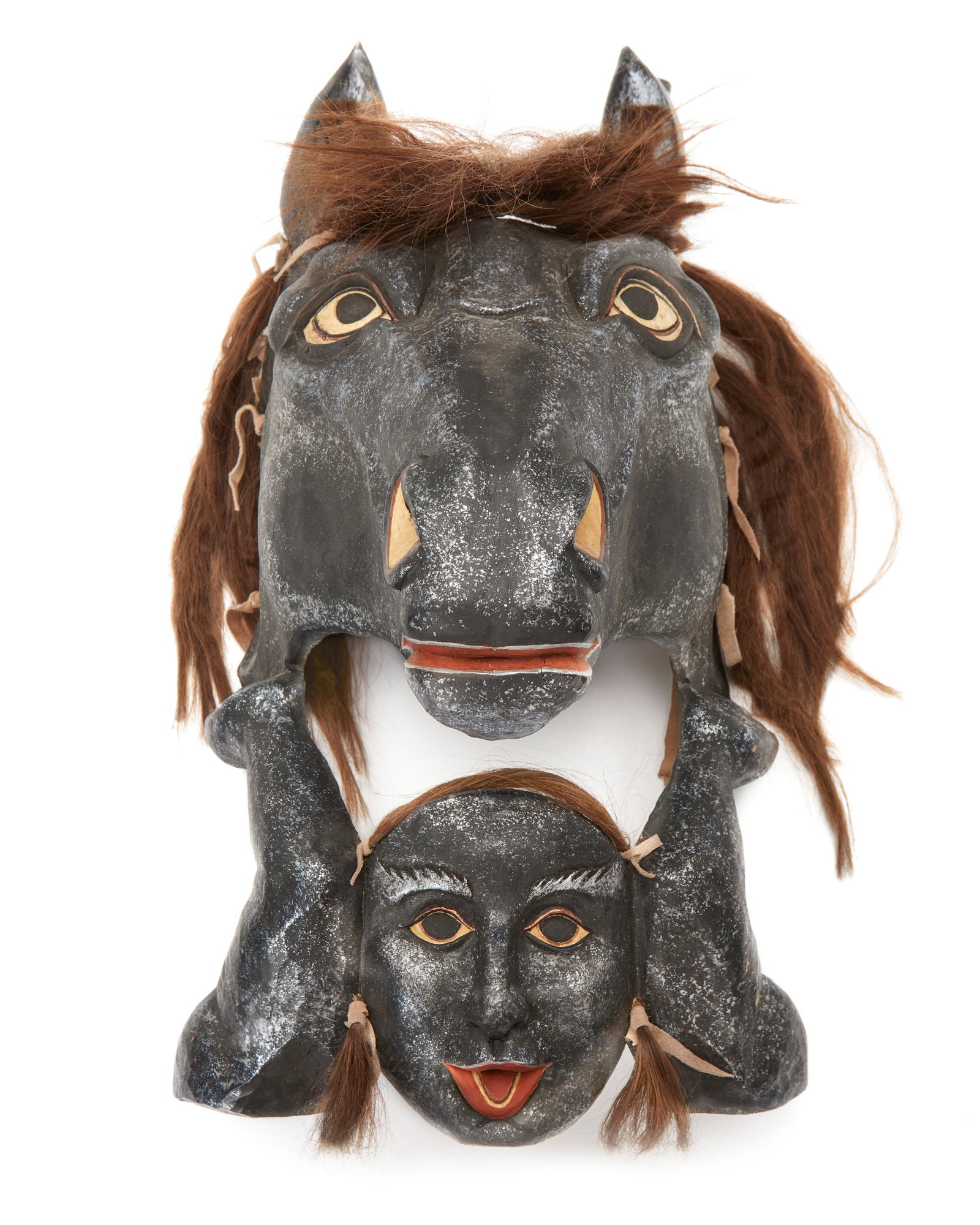 A traditional-style contemporary carved wood horse mask: Late 20th/early 21st Century With incised artist's cipher to verso Possibly by Rick McKenzie, the polychromed carved wood mask with metallic highlights and horse hair 20.25" H x 11.25" W x 11" D