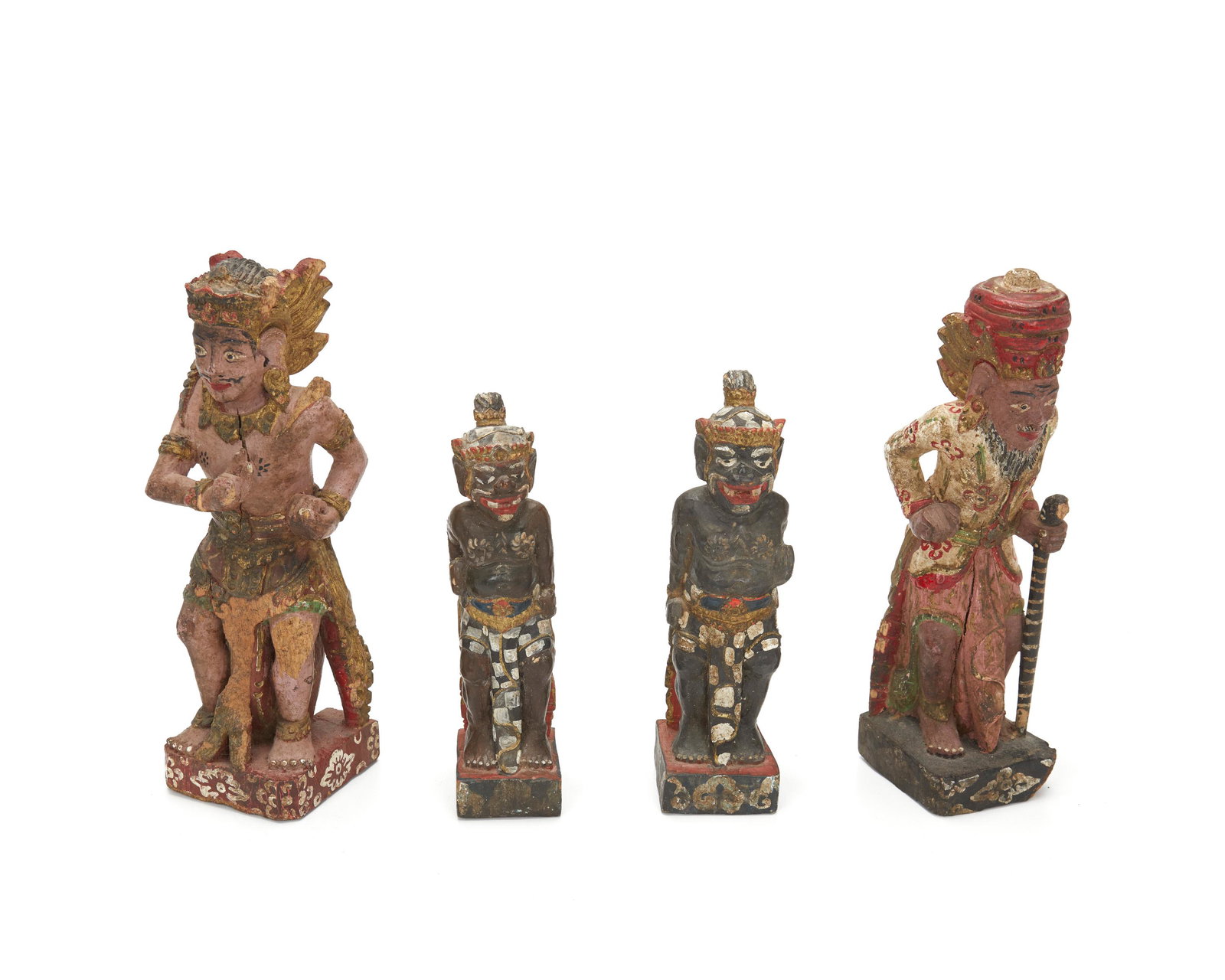 Four Balinese carved wood devotional figures: 20th Century Each polychromed carved wood with gilt highlights, 4 pieces Largest: 9.5" H x 3" W x 2.875" D; Smallest: 7.375" H x 1.875" W x 2.125" D