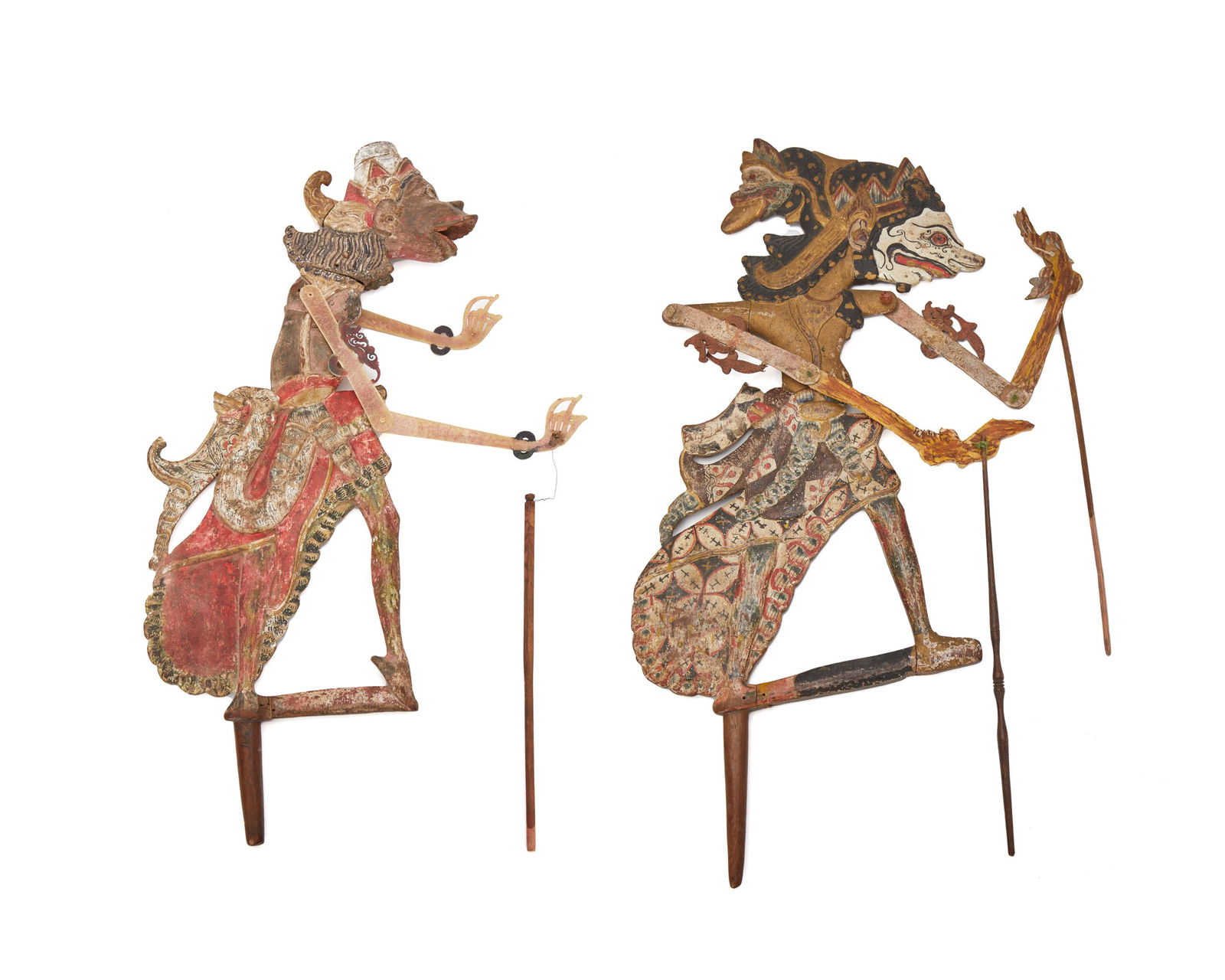 Two Indonesian polychromed wood shadow puppets: 20th Century One illegibly inscribed Each with articulated arms, 2 pieces Larger: 23.5" L X 30" W; Smaller: 19.5" L x 17.5" W Provenance: The Collection of Joseph Fischer, Berkeley, CA Obtained