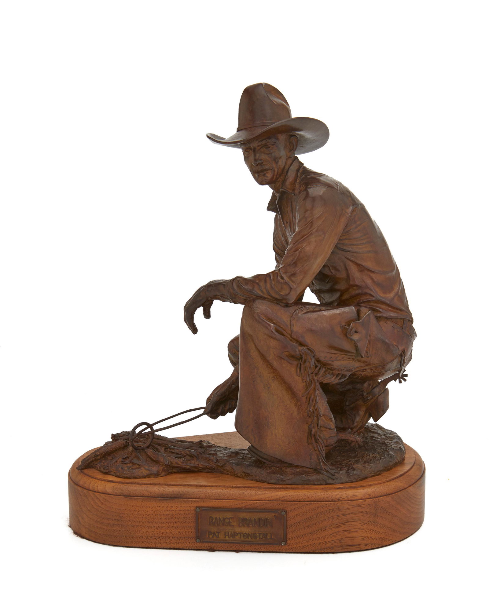 Pat Haptonstall (1943-1995, Arizona): "Range Brandin'," 1984 Patinated bronze on wood base Edition 10/16; signed: Pat Haptonstall [copyright symbol]; further inscribed: DYK; titled to plaque 10.25" H x 8.5" W x 5.5" D Notes: This lot is a