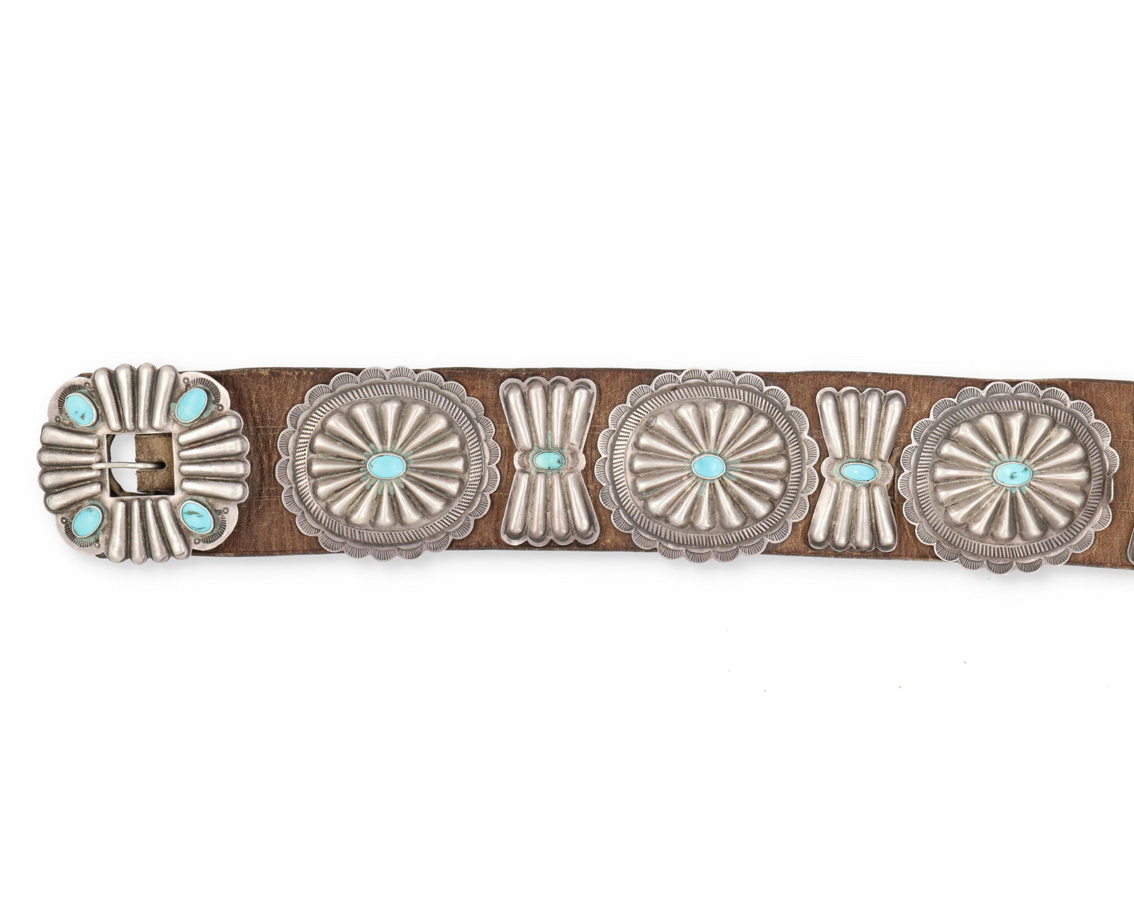 A Navajo/Diné silver and turquoise concho belt: Mid-20th Century Designed with six conchos (each: 2.5" H x 3" W) alternating with five butterflies (each: 2.125" H x 1.125" W) and one buckle (2.5" H x 3" W), each set with a single turquoise and atta
