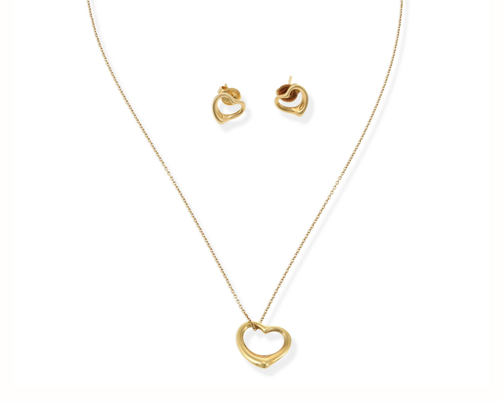 A set of Elsa Peretti for Tiffany & Co "Floating: 18k yellow gold, each stamped: Tiffany & Co. / Peretti / 750 / Spain (C) Comprising a pair of stud earrings (.4" W) and a detachable pendant with neck chain (16" L x .5" H), with a signed slip pouch 5