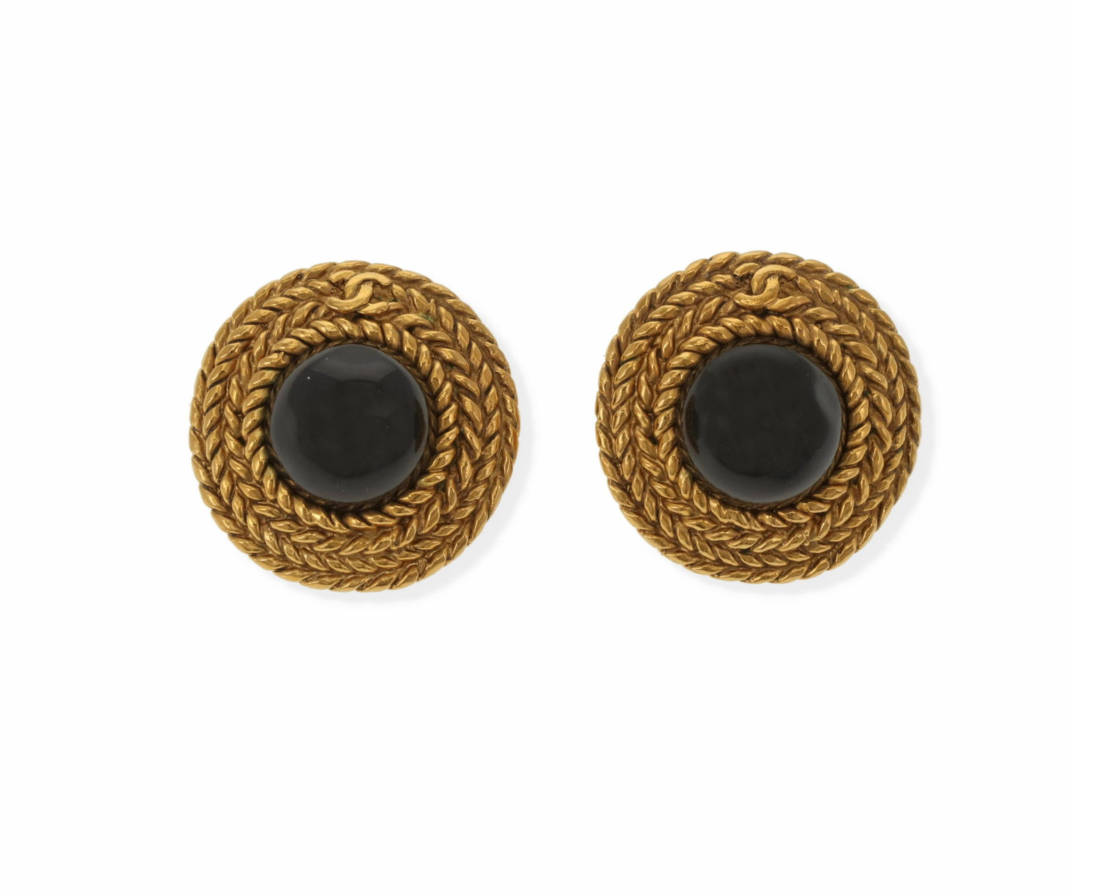 A pair of Chanel black gripoix ear clips: Gold toned textured metal, stamped: [with double "C"] / Chanel / Made in France / (C) The round ear clips centering black glass within a woven rope frame 1.25" W 2 pieces