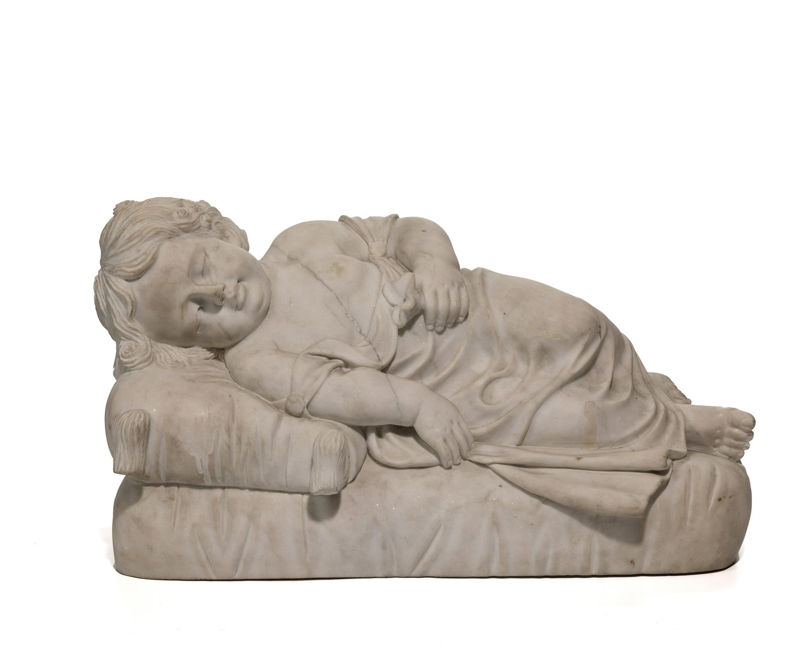 A French carved white marble reclining sleeping baby: 19th Century Depicting a draped baby with curly hair sleeping on a cushion and holding a lily 12.5" H x 22" W x 9" D