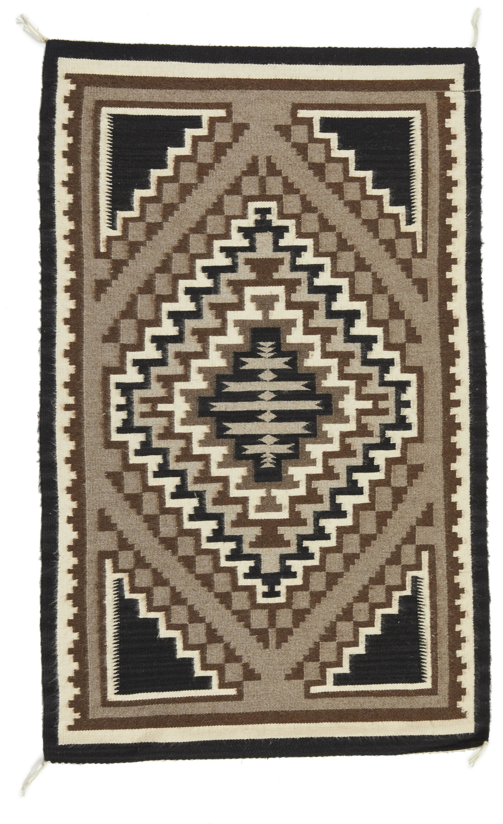 A Navajo Two Grey Hills rug: 20th Century, Dine Woven in black, grey, cream, and brown wool with four corner elements and central diamond 50" L x 32" W