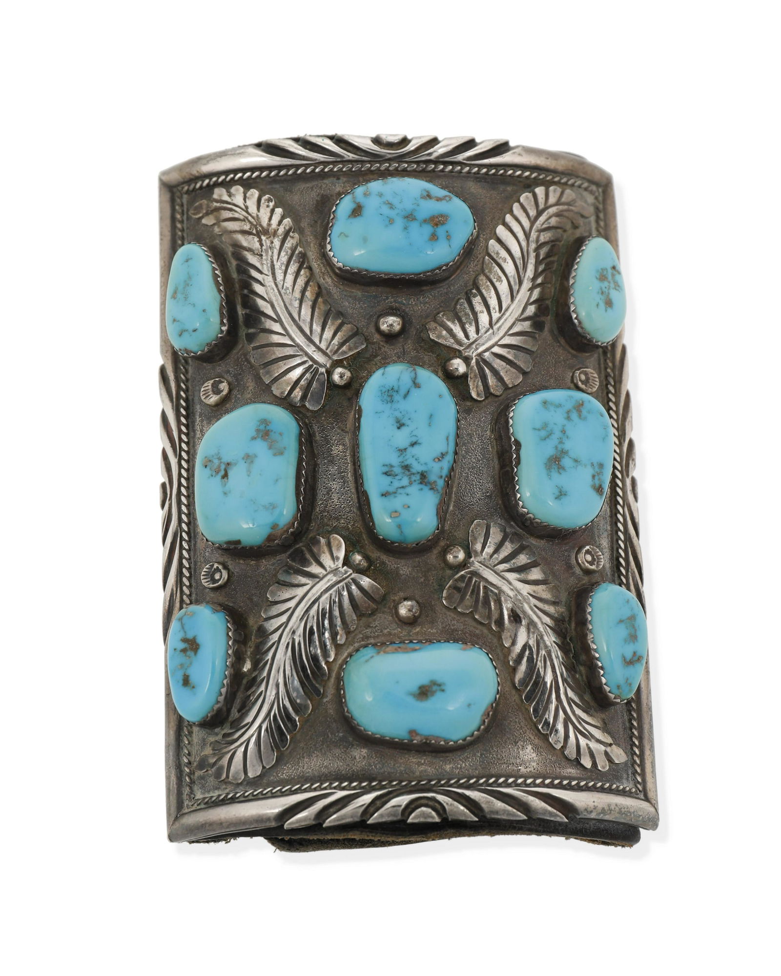 A Navajo silver and turquoise ketoh arm guard: Second-Half 20th Century, Dine Appears unmarked A ketoh with a sandcast applied feather X-motif to the central plaque and set with nine turquoise stones all within a raised border, tightly attached
