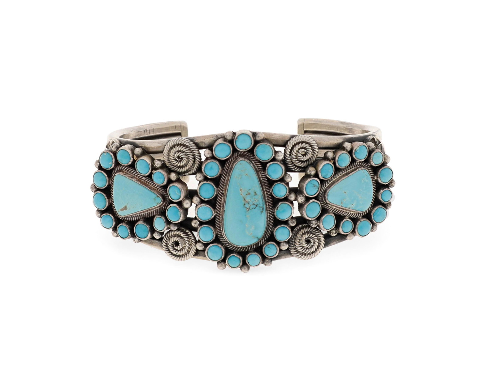 A Gary Reeves Navajo cluster turquoise and silver cuff: (1962-2014, Dine) Stamped terminals: G. Reeves / Sterling A five wire cuff featuring three plaques of cluster set Lone Mountain turquoise with applied wire and silver stampwork decoration 6.5" total i