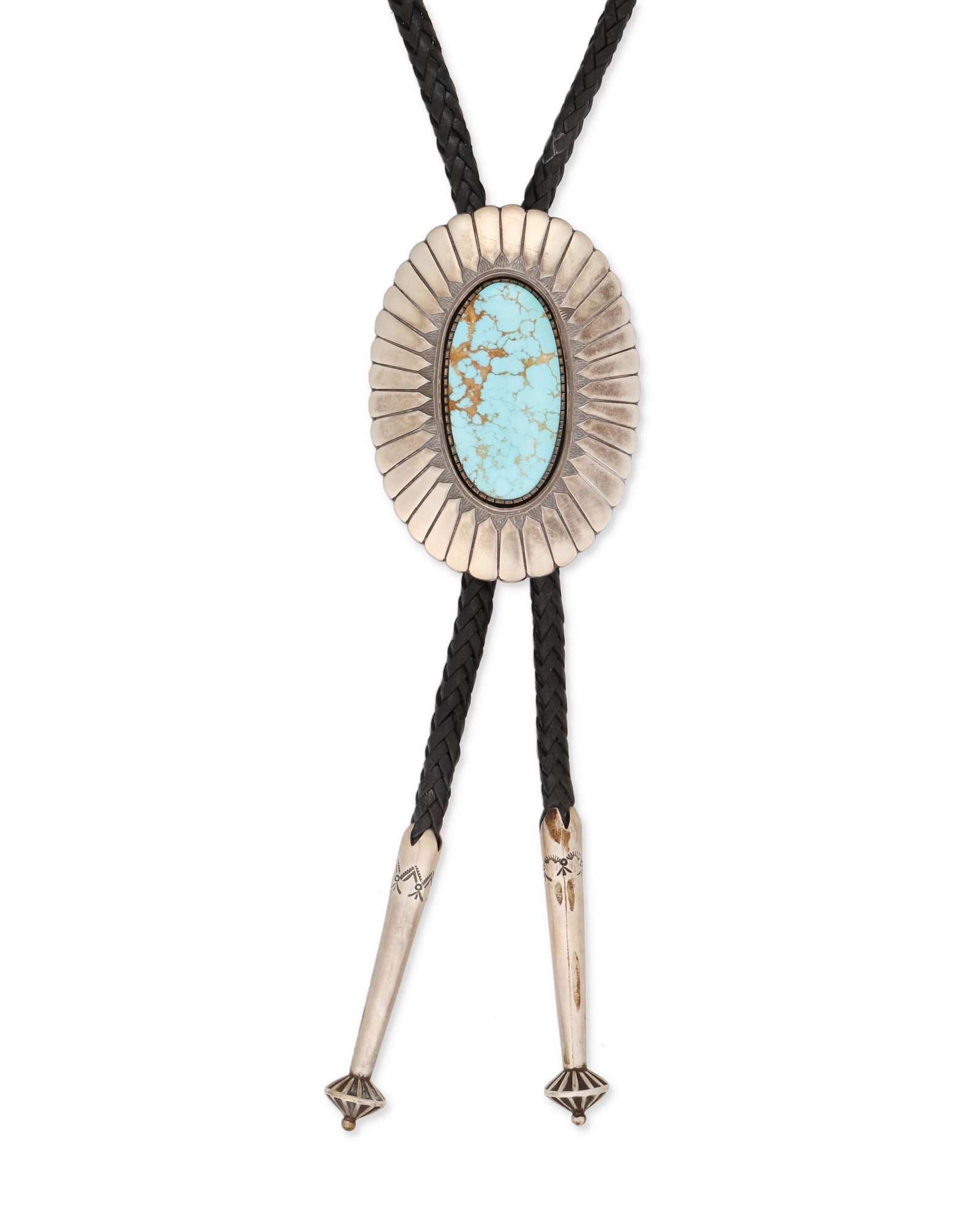A Terry Martinez Navajo silver and turquoise bolo tie: Late 20th/Early 21st Century, Dine Stamped: TM [Terry Martinez] / Sterling An oval silver bolo with hand-chiseled feather motif set with a large oval cabochon number 8 turquoise, with a figure eight w