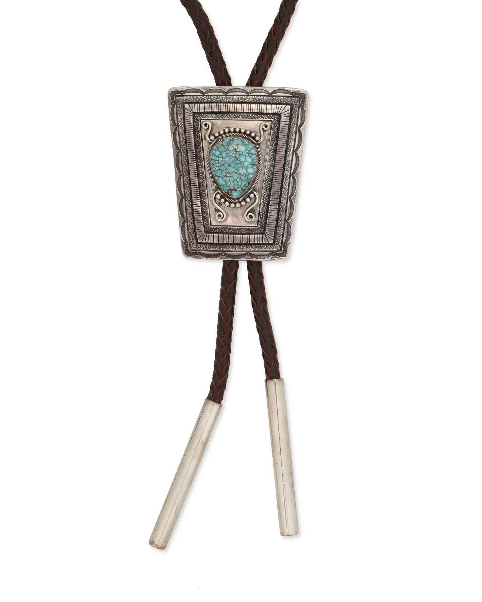 A Howard Nelson Navajo silver bolo tie: Late 20th/Early 21st Century, Dine Stamped: Howard [Howard Nelson] / Sterling A trapezoidal bolo with stamped and applied motifs set with a teardrop turquoise cabochon, finished with cylindrical tips 