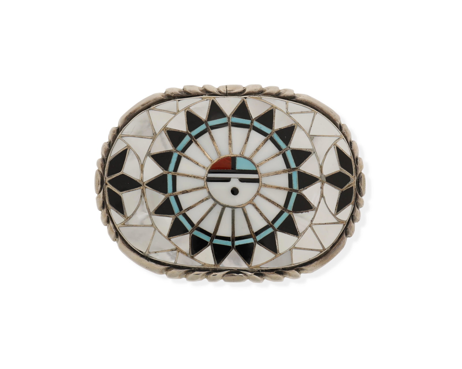 A Zuni inlaid sterling silver belt buckle: Second-Half 20th Century Stamped: RLK [for Ralph and Lillie Kallestewa] / Sterling A multistone inlaid Sun Face buckle, including mother of pearl, turquoise, onyx, and coral 2.5" H x 3.5" W 97.3 grams