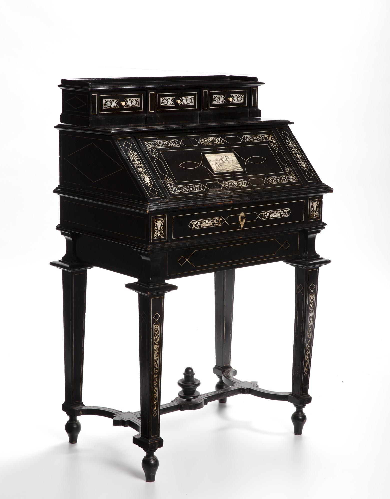 An ebonized wood and bone marquetry writing desk: Third-Quarter 19th Century The slant-top writing desk surmounted by an upper compartment with three drawers atop a fitted interior with three pigeonholes over a long drawer, raised overall on four tap