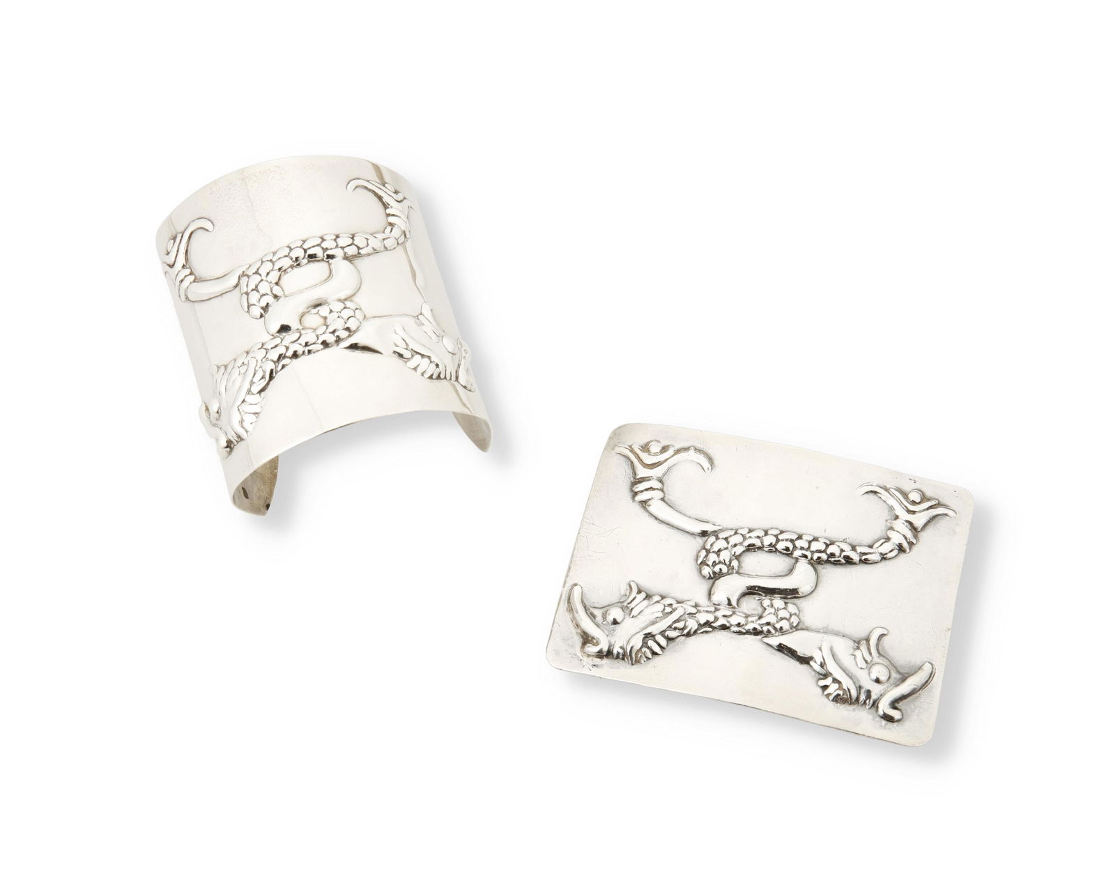 Two Hubert Harmon silver repousse serpent pieces: 1944-1948; Mexico Each stamped: Hubert Harmon / Made in Mexico / Sterling; Buckle stamped with winged feet for Hubert Harmon Comprising a wide silver cuff bracelet with a double entwined repousse fi
