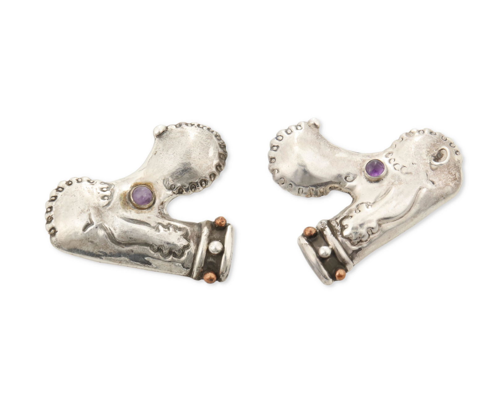 Two Hubert Harmon silver and amethyst poodle brooches: 1944-48; Mexico Each stamped with winged feet for Hubert Harmon; Further stamped: Hubert Harmon / Sterling / Made in Mexico Each poodle brooch made in silver with copper studs to collars and amethys