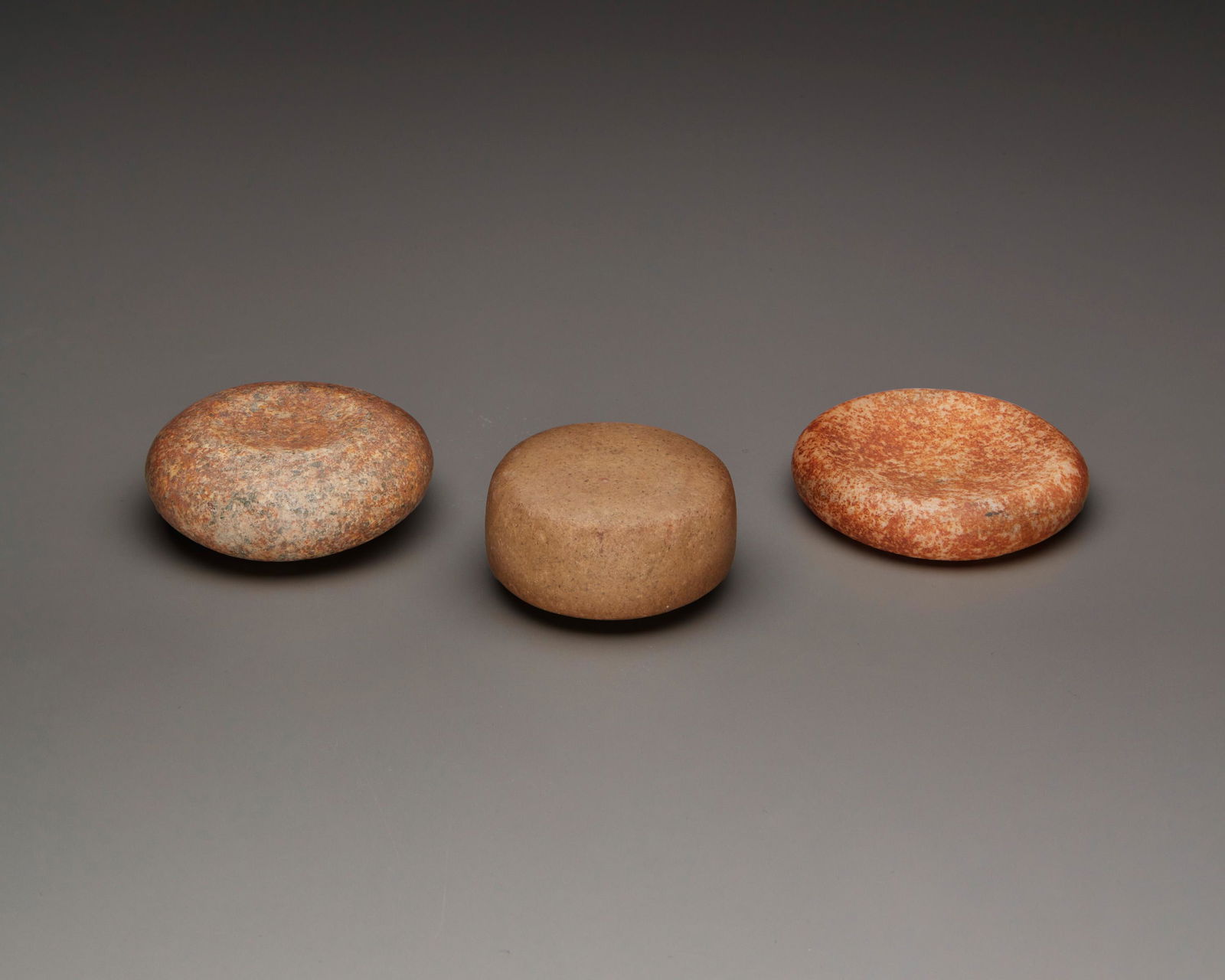 Three carved stone discoidals (1 of 2)