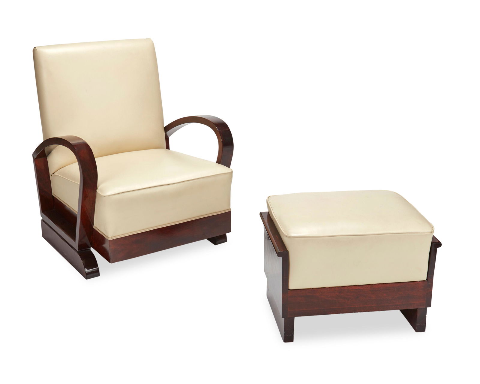 A Christian Krass lounge chair and ottoman: First-Quarter 20th Century; Paris, France The French Art Deco lounge chair with a cream leather upholstered back and seat on a wood frame flanked by upward curving arms with a box seat rail raised on