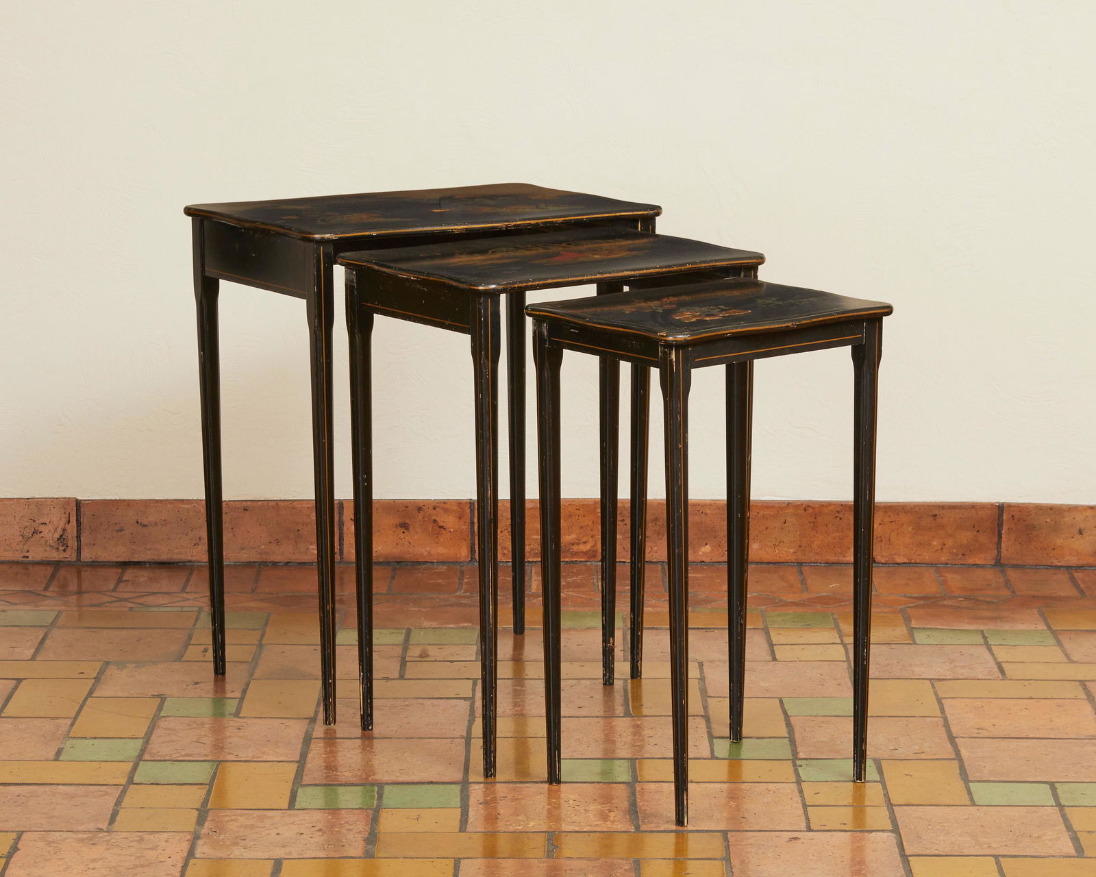 A set of Japanese-style nesting tables: 20th Century Comprising three lacquered wood nesting tables with painted and enameled Japanese-style landscape scenes, 3 pieces Larger: 25" H x 21" W x 15" D; Smaller: 23" H x 14" W x 11" D Proven
