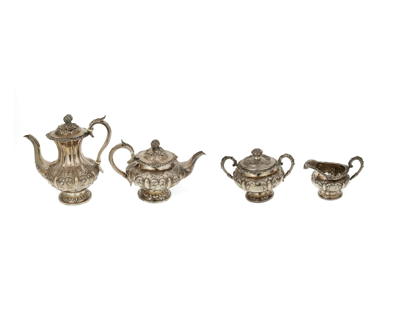A Victorian sterling silver tea and coffee service: 1839 and 1843 Each with English sterling hallmarks for London, Tea and coffee maker's mark: W [dot] H; Sugar and cream maker's mark: WH Each with elaborate foliate motifs, comprising a matching coff
