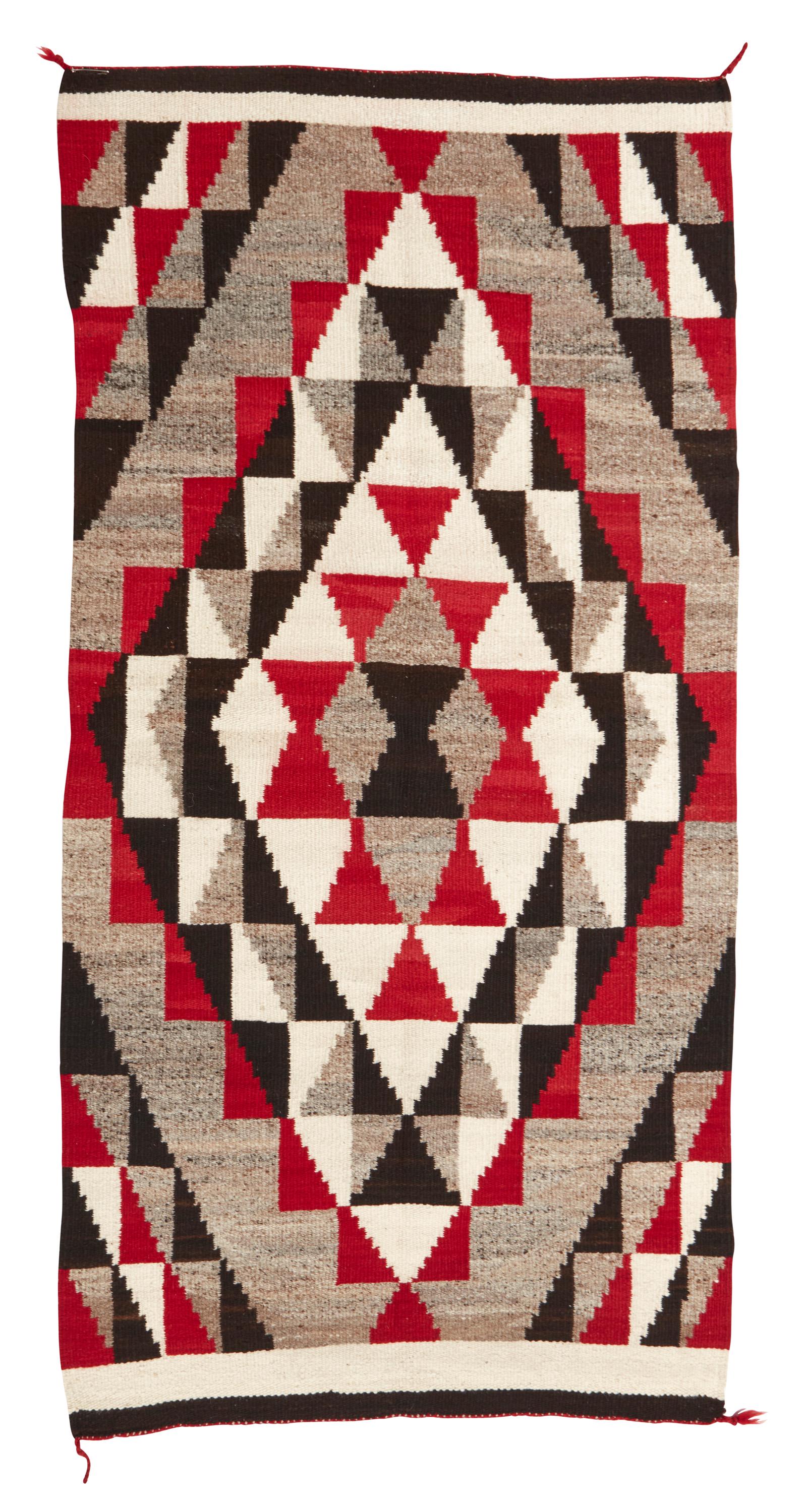 A Navajo Regional rug: Mid-20th Century; Dine Woven in red, dark brown, light natural brown, and cream wool with central radiating stepped diamond 72.25" H x 37" W Provenance: Acquired from Alexanian Rugs in 2003