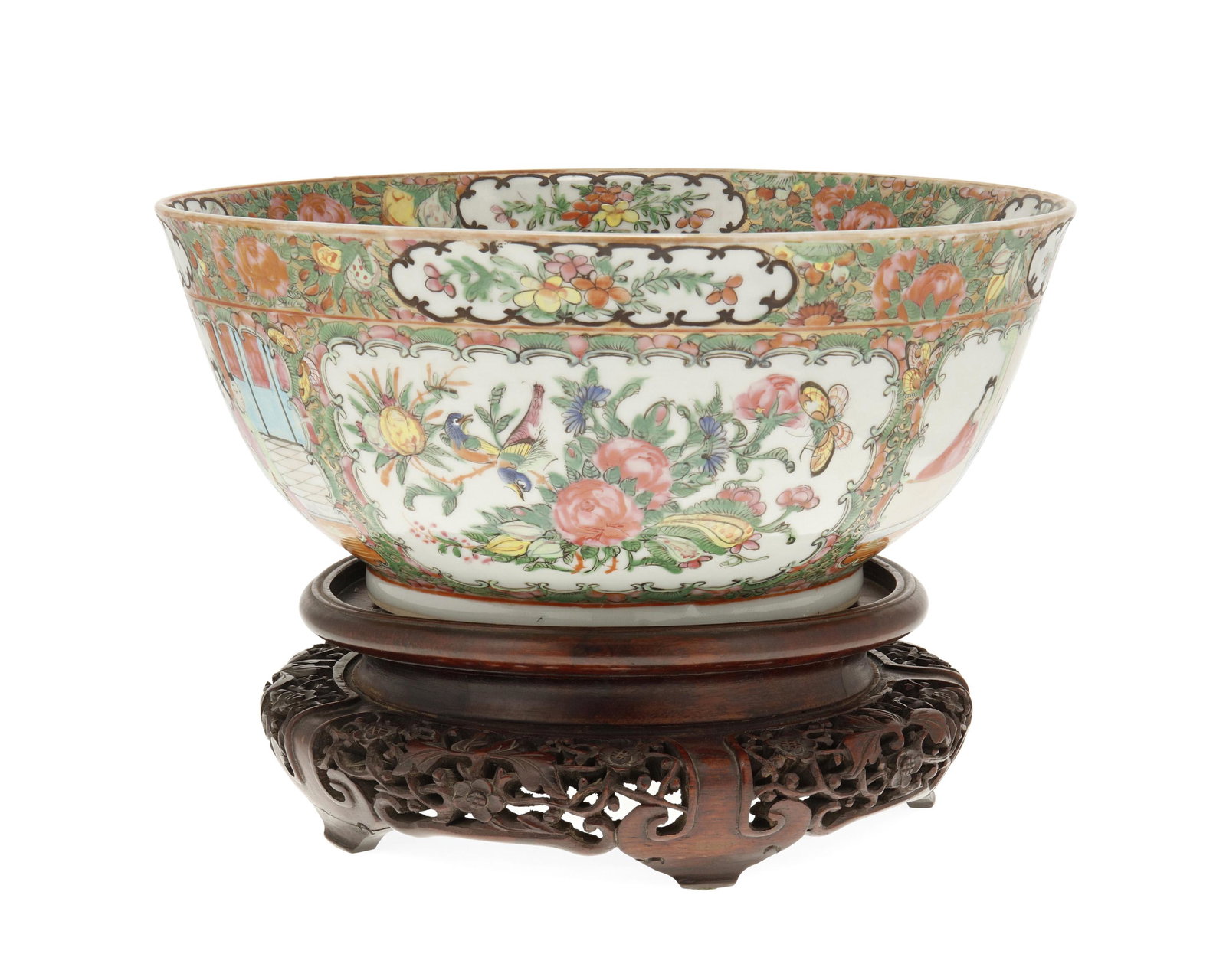 A Chinese famille rose porcelain bowl: Second Half 19th Century, Qing Dynasty (1644-1912) The glazed porcelain bowl with painted polychrome registers depicting floral sprays and figural scenes, on a carved wood base Bowl: 5.5" H x 11.625" 