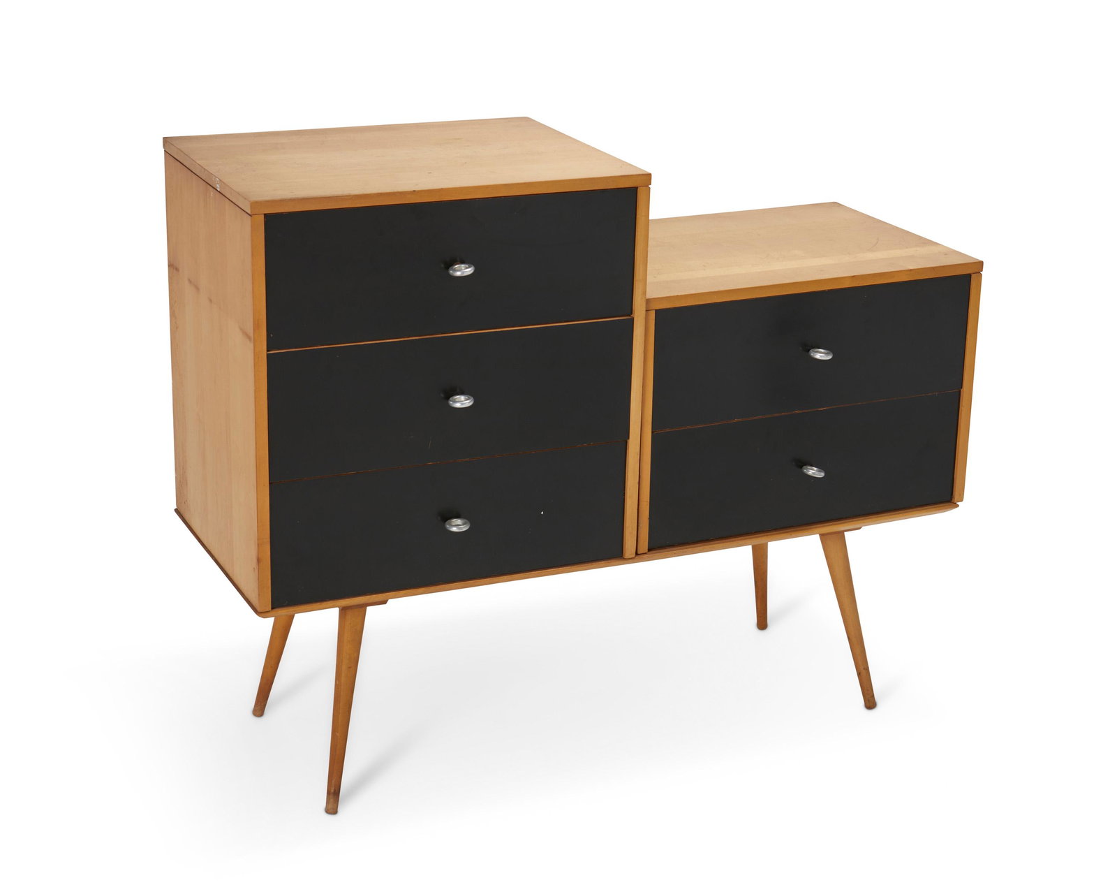 Paul Winthrop McCobb (1917-1969, American): Planner Group modular cabinet for Winchendon, circa 1955 With Winchendon Modern paper label; Numbered: 1544 Two modular maple chests of drawers with black finish and steel loop handles raised on a c
