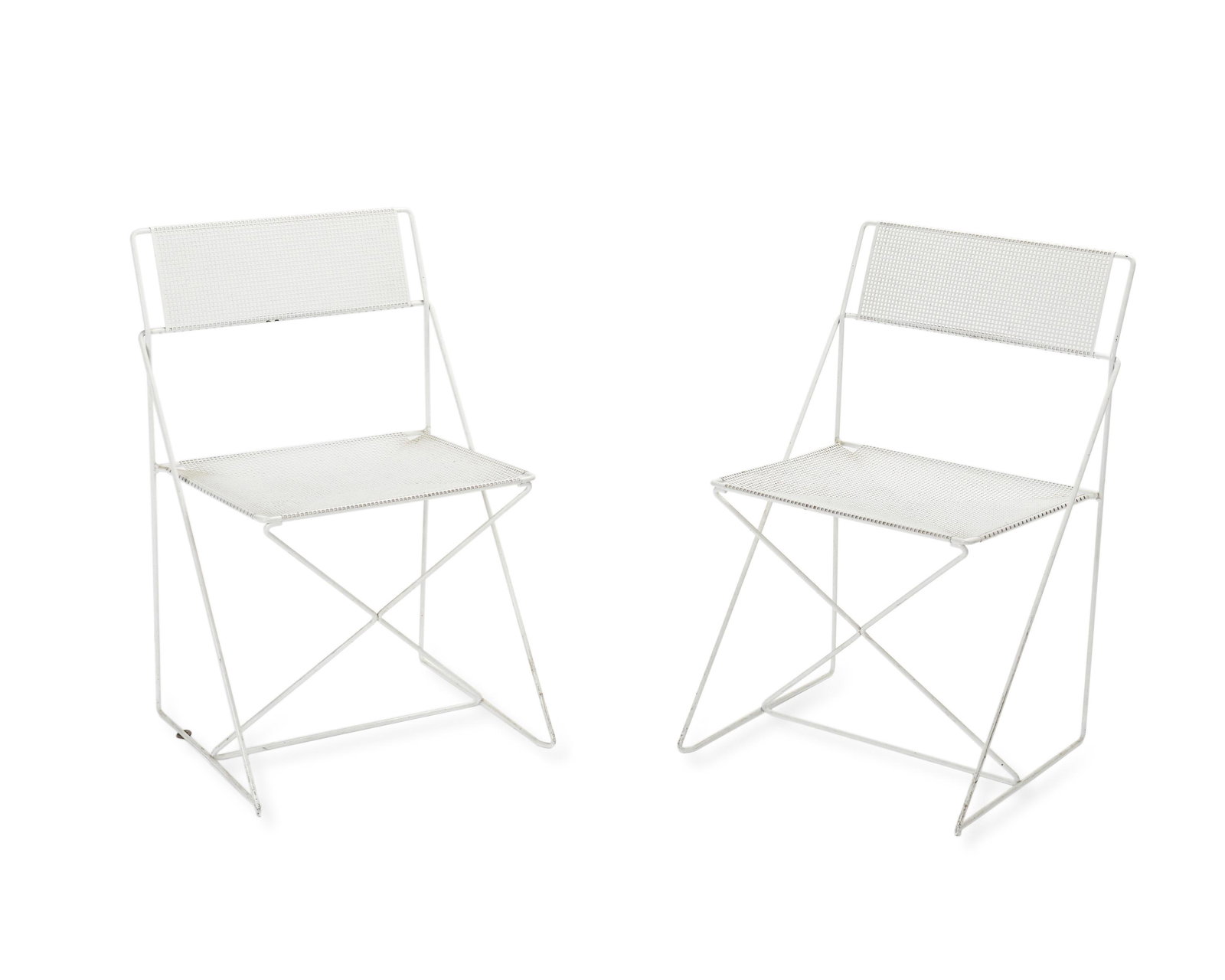 A pair of mid-century modern iron mesh outdoor chairs: Mid-20th Century Each with square-punched perforated metal seat and back on an iron frame with a white finish, 2 pieces Each: 30" H x 19.25" W x 16" D