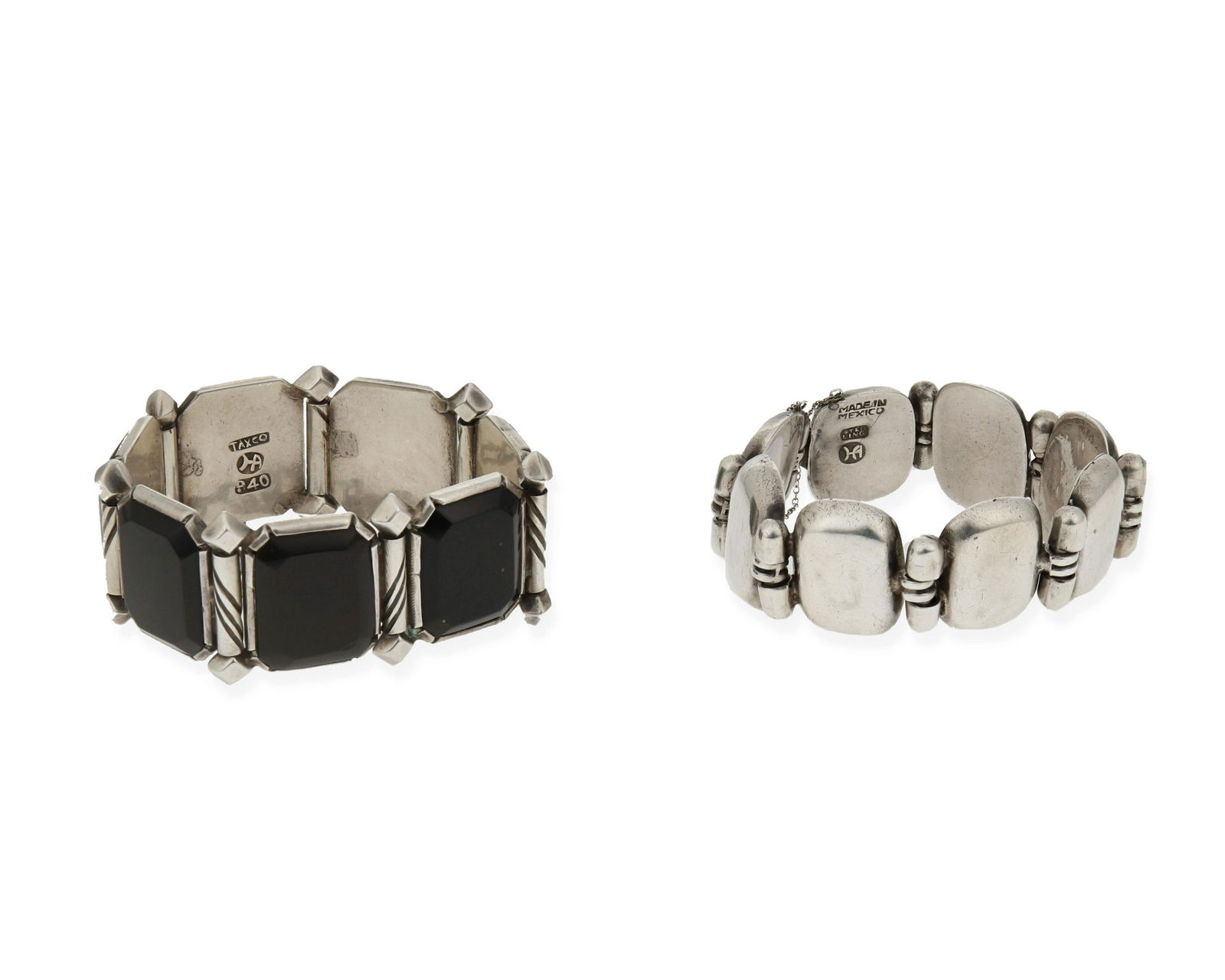 Hector Aguilar (1905-1986, Mexican): Two silver link bracelets; circa 1940-1945; Taxco, Mexico Each stamped: HA / 940 / Taxco Comprised of one bracelet with panel set onyx links and incised bar spacers (7.5" L x 1.125" H) and one brace
