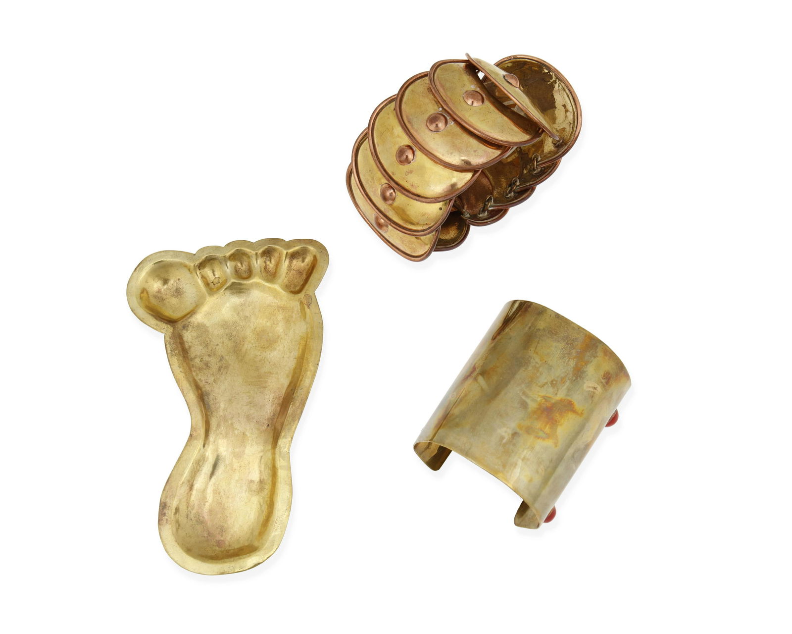 Hubert Harmon (1913-2004, American): A group of brass jewelry items, circa 1942-1948; Taxco, Mexico Each stamped: Hubert Harmon / Mexico Comprising an armadillo link bracelet with copper accents (8" L x 2.25" H), a wide brass cuff brac